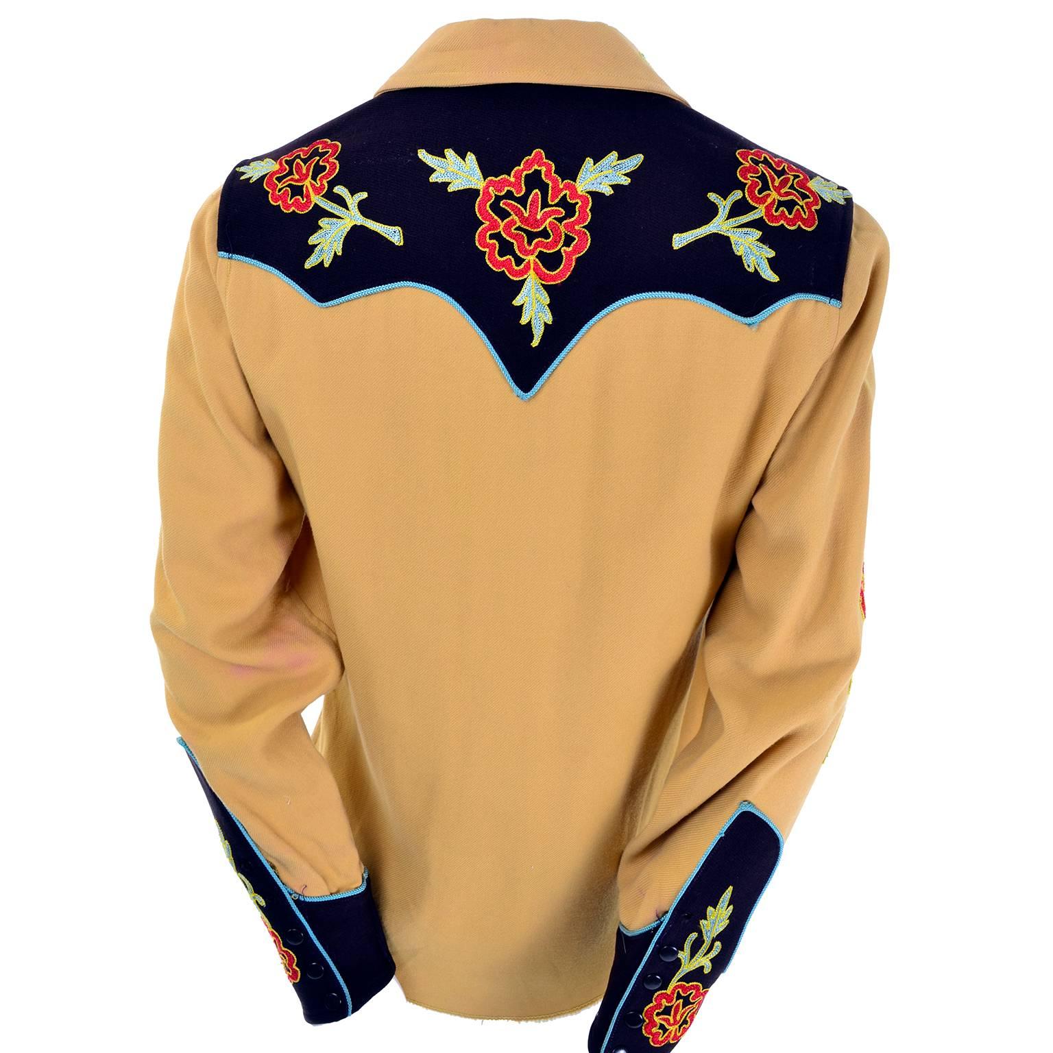 This vintage gold wool gabardine western shirt was made by Vaquero Fashions.  The shirt snaps up the front and has blue trim and embroidered flowers. We acquired this from an estate we were fortunate to be able to handle that included vintage 1940's