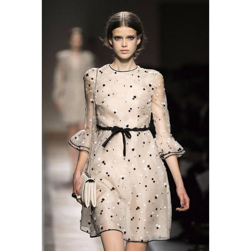 This is an absolutely gorgeous Valentino dress in a cream Silk and Cotton blend organza, lined with 100% silk. Beautiful, delicate details include the small black and white knit flower appliques and dots on the outer layer of chiffon, 3/4 length