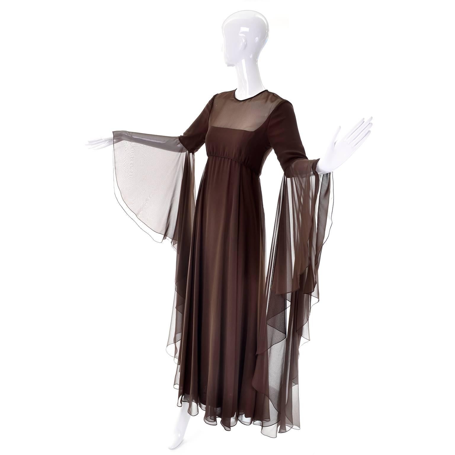 This is an outstanding vintage brown chiffon evening gown from Estevez for the Eva Gabor Look. This full length dress has dramatic statement sleeves that are are lined to the elbow.  The sleeves drape almost to the floor!  There is an empire waist