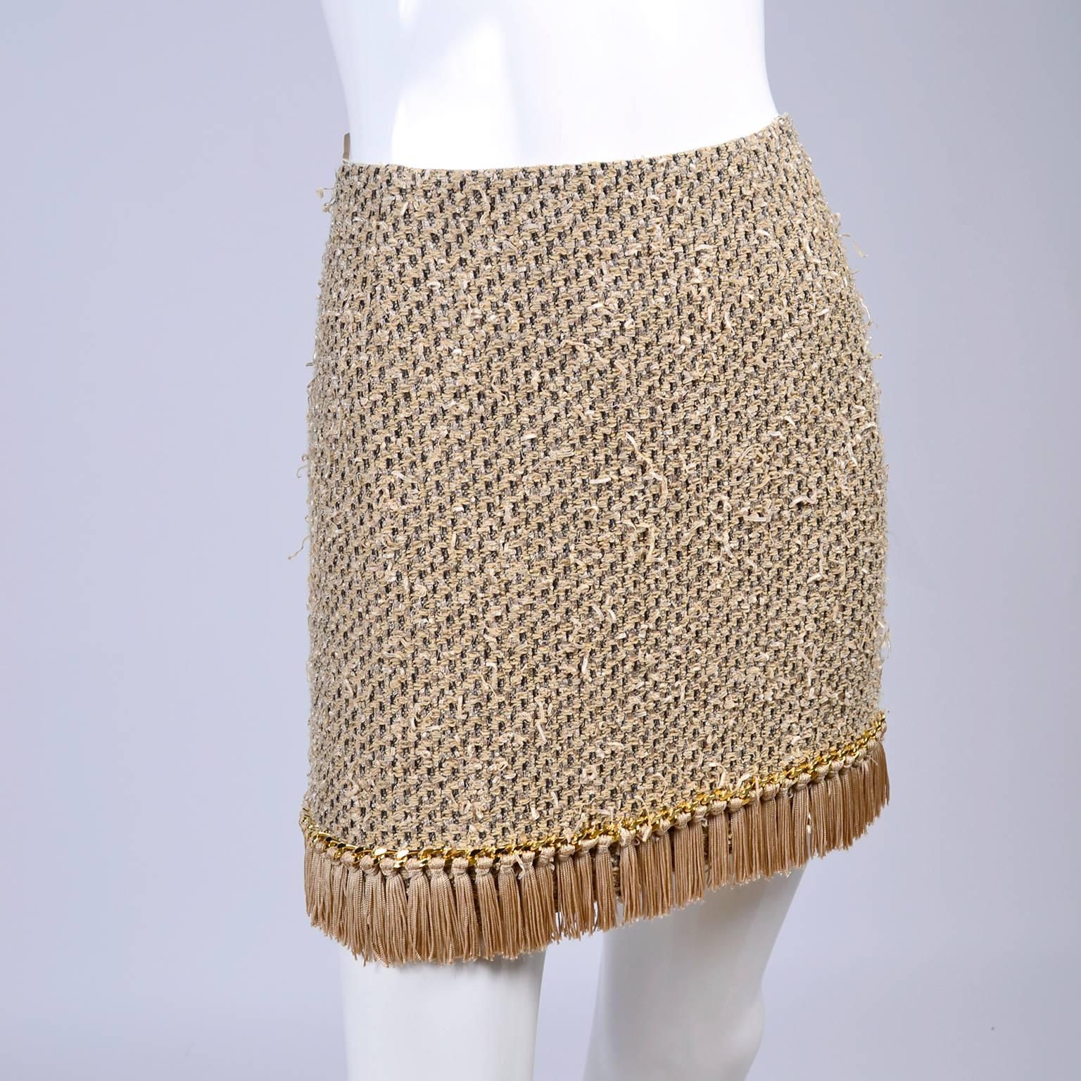 This is a fab Moschino light brown skirt with woven ribbons of different shades of tan and brown. To accentuate the ribbon effect, some pieces of the satin tan ribbon is distressed and sticking out all over the skirt. It also has fringe along the