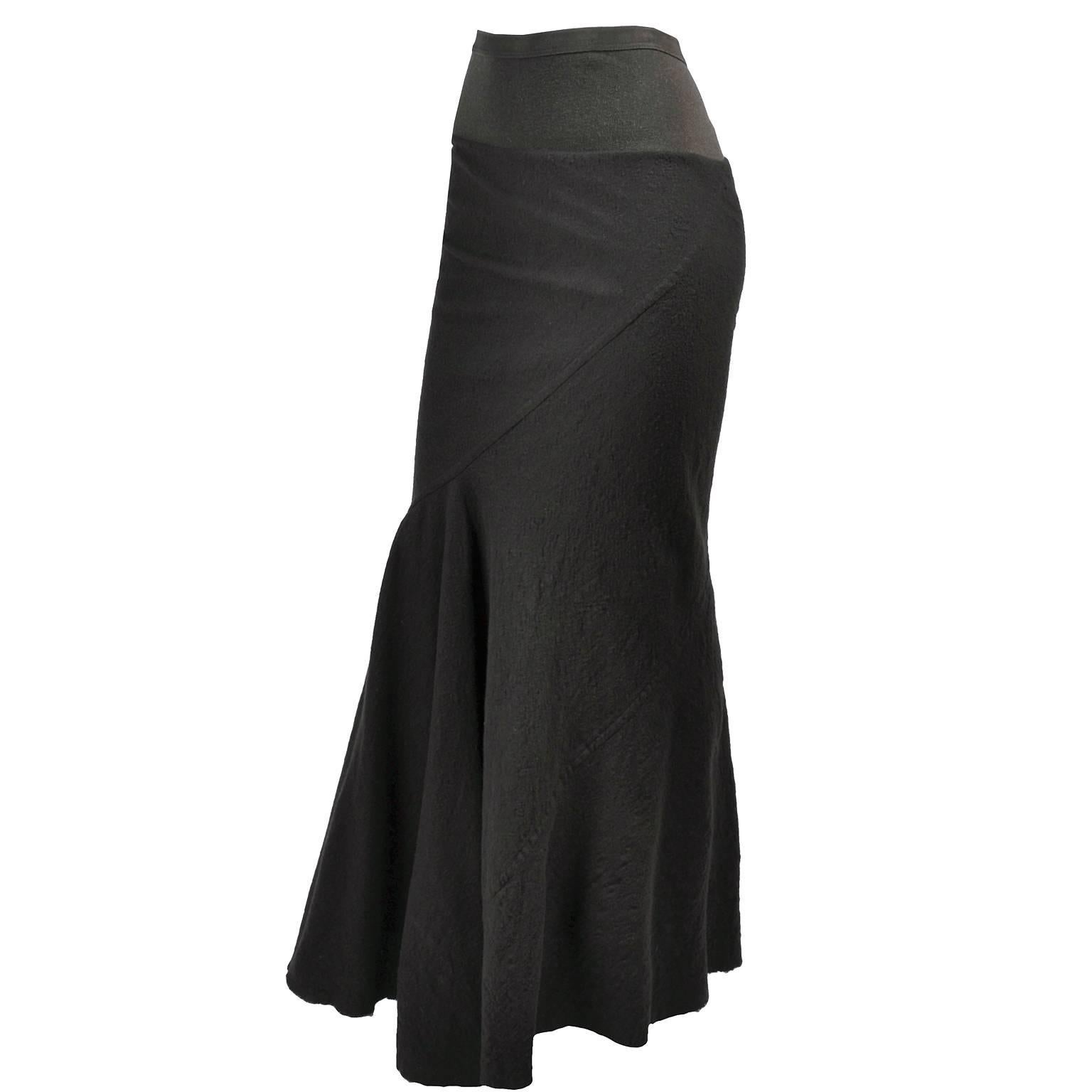 Rick Owens distressed maxi skirt from the Fall Winter 2006 Queen collection. This long dark green skirt is lined in a rayon/silk blend. This skirt has an avant garde look with asymmetrical seams across the skirt, a fishtail flair at the end of the