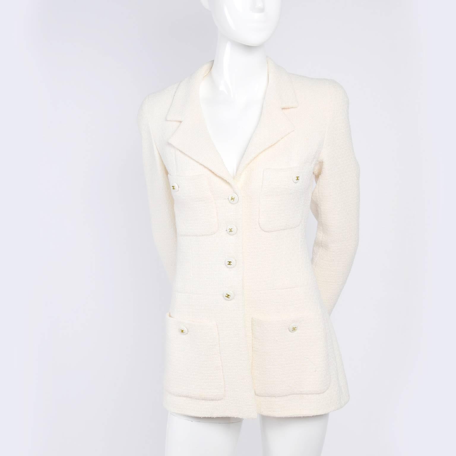 This is an absolutely gorgeous vintage Chanel blazer or jacket with CC logo buttons and tone on tone CC logo printed silk lining.  The jacket is in an ivory, almost cream wool blend fabric and it has 4 front pockets and a notched collar.  This