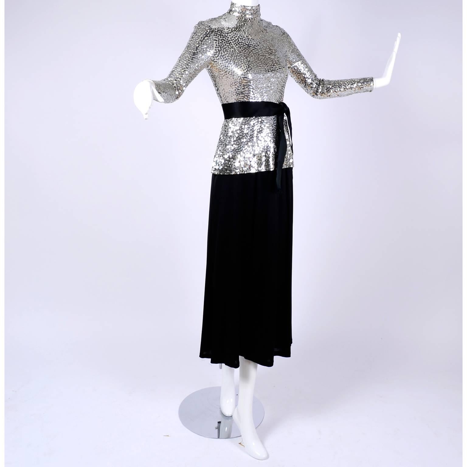 This vintage 2 piece dress was designed by Norman Norell. The long sleeved top is covered in brilliant silver sequins and it is paired with a simple black skirt. Please press 