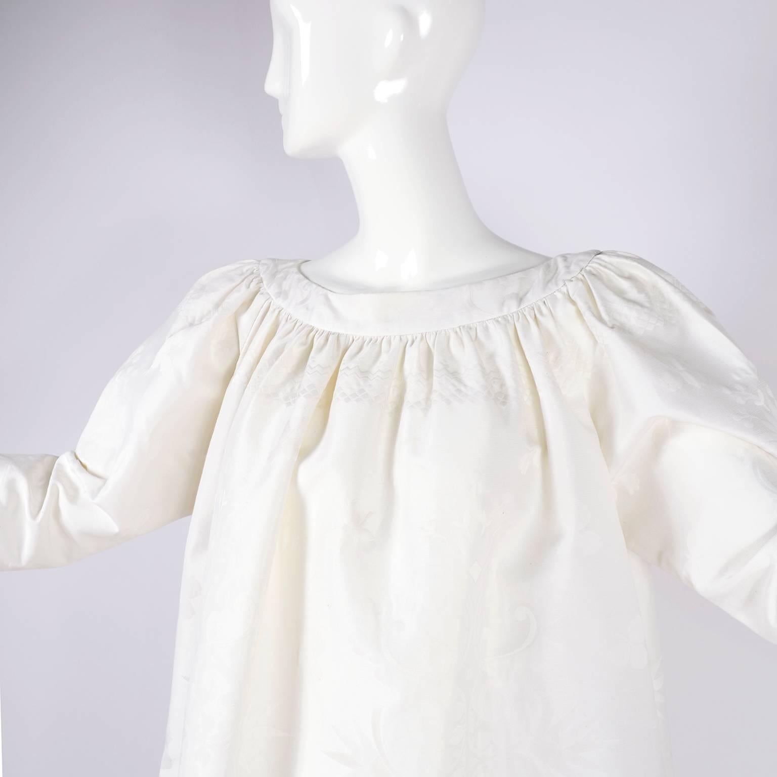 This is a fabulous summer dress or tunic from Christian Lacroix from the 1980's in white linen. Though labeled a French size 38, this dress is oversized and almost a one size fits all. This wonderful tone on tone white damask patterned dress fits up