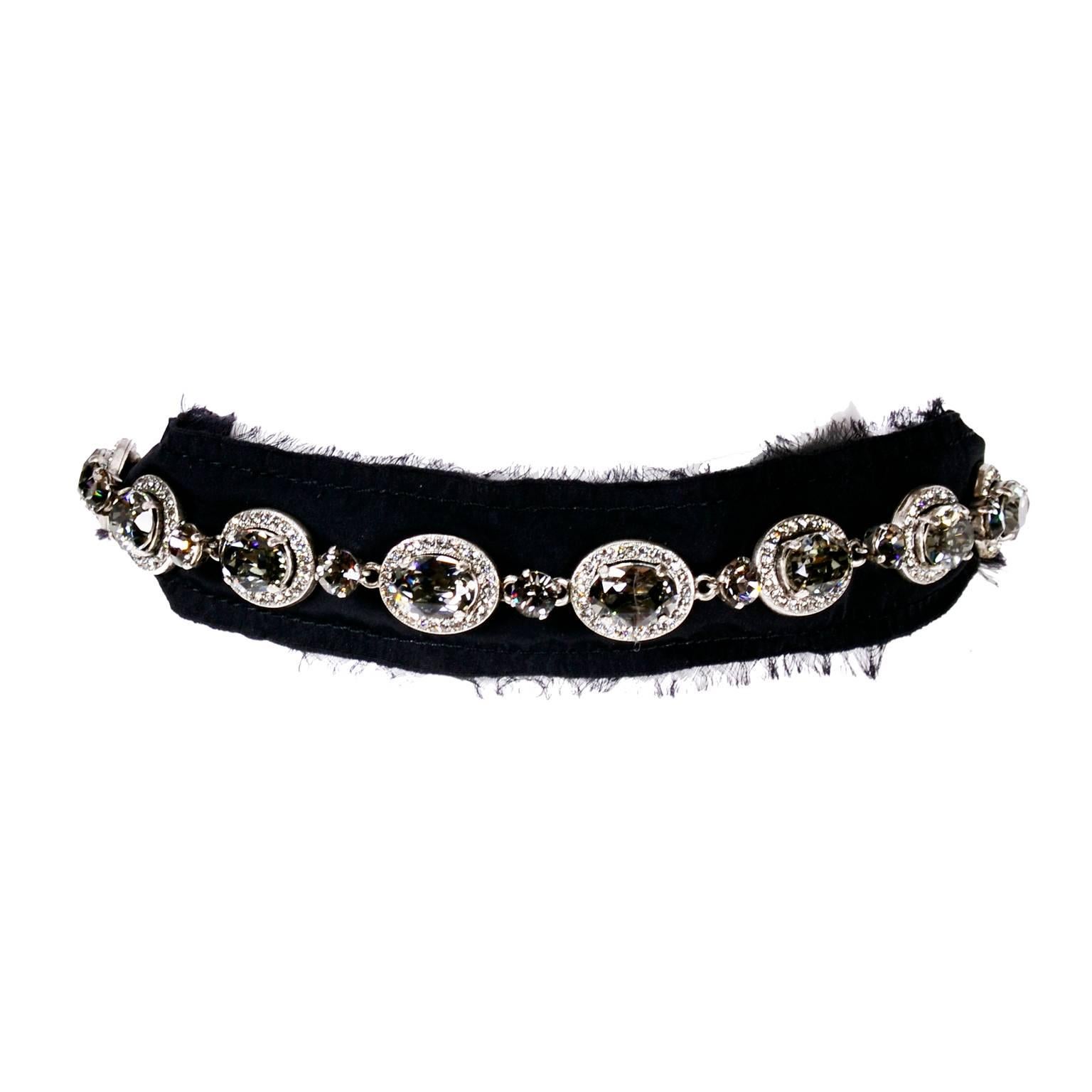 This is an absolutely gorgeous Lanvin Ribbon Necklace in black silk with raw edges and 18 x 20 mm jeweled smokey crystal ovals surrounded by clear crystals and a silver link chain with spring ring clasp. This necklace was designed by Alber Elbaz and