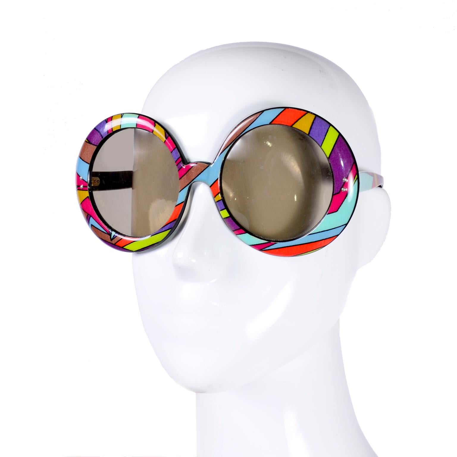 These are a pair of fabulous Emilio Pucci vintage sunglasses from the late 1960's or early 1970's. Vintage Pucci eyewear is always great to find and this pair of glasses has a great Pucci signature print in shades of orange, brown, blue, purple,