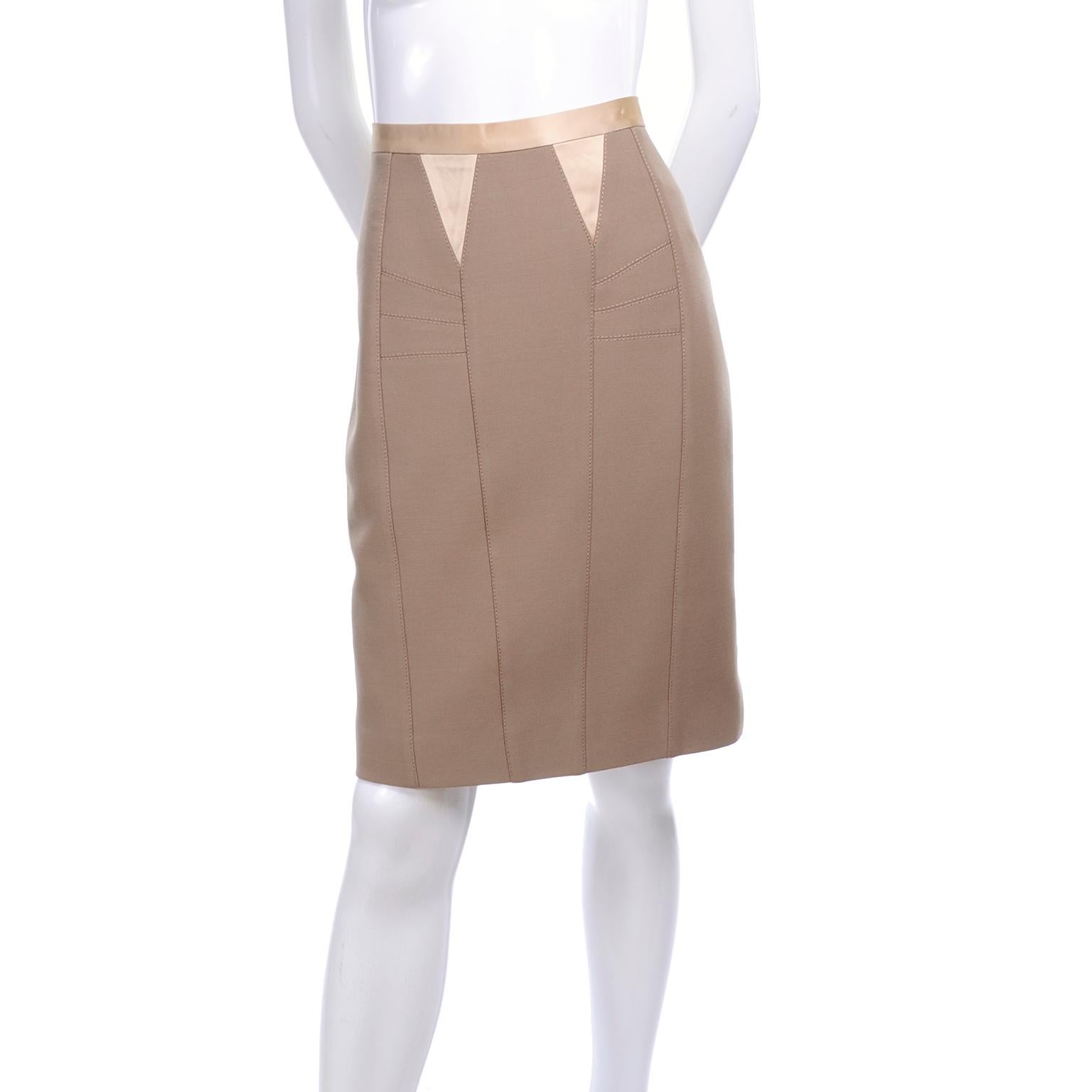 This is a beautiful Dolce and Gabbana pencil skirt with satin trim and wonderful seam and dart detail.  The skirt is labeled an italian size 42 and is 90% wool and 10% acetate. There is a back zipper with a snap and the skirt is lined with a pretty