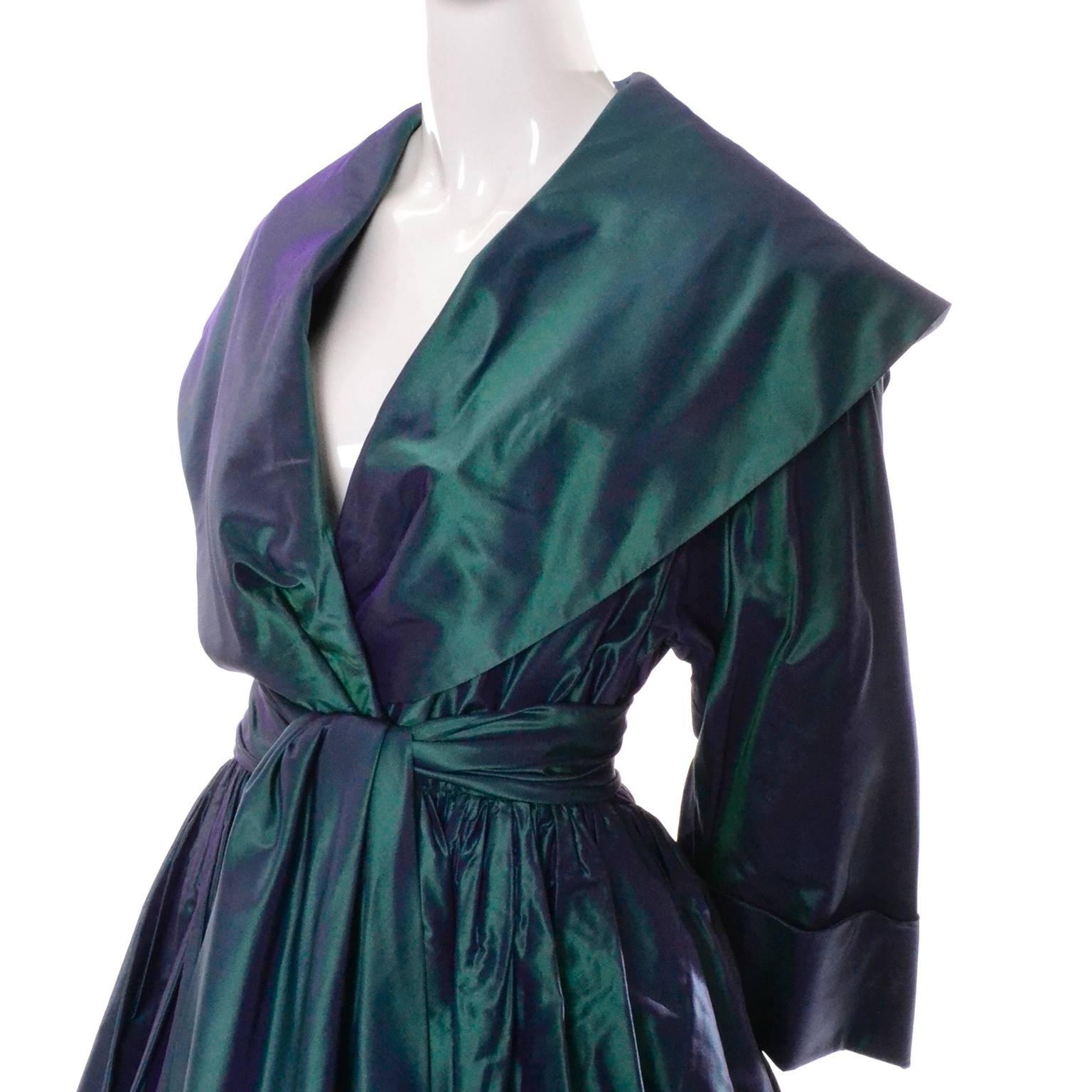This stunning vintage evening gown was designed by Carolyne Roehm and purchased at Bergdorf Goodman in the 1980's.  This iridescent peacock blue / green dress is made of a gorgeous taffeta and closes at the waist with a snap and hook and eye.  There