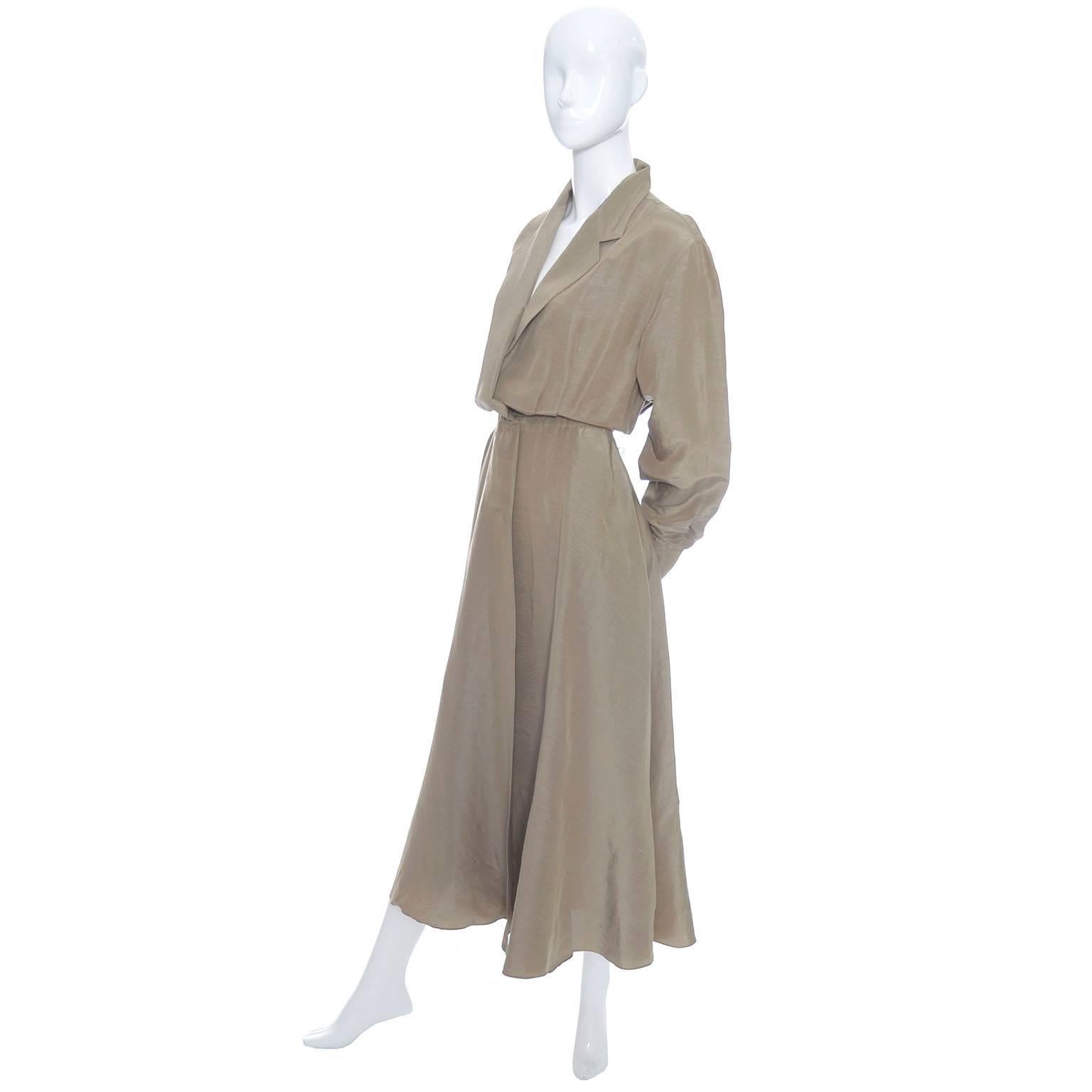 This vintage Donna Karan dress is 65% linen and 35% silk and it is in excellent condition. This dress has side slit pockets, a full skirt, and snaps to close. The color is a bronze-taupe and the dress has long sleeves and pretty lapels at the deep V
