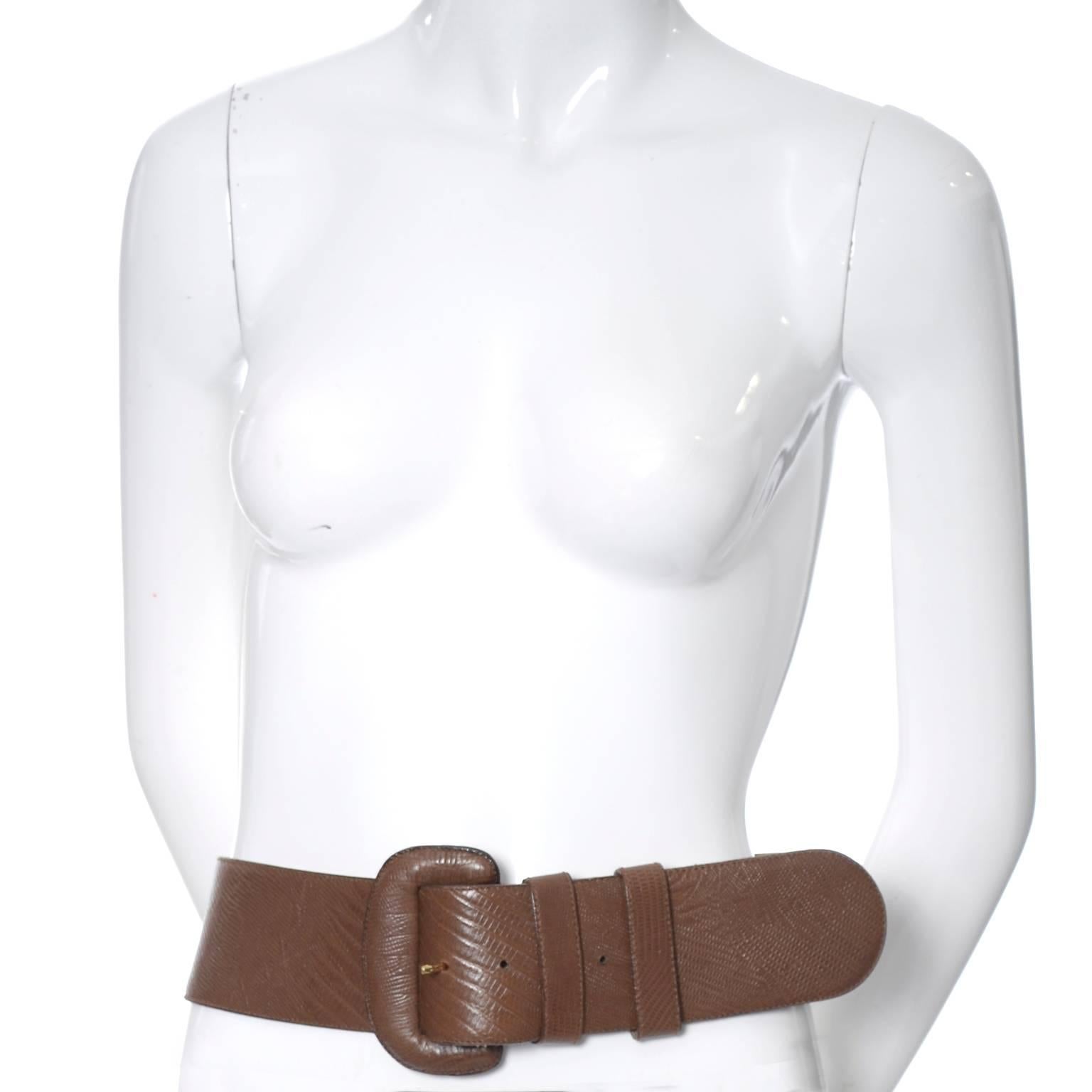 This is a vintage leather belt from Donna Karan. The belt is in excellent, as new condition and was made in Italy in the 1980's.  It is in a pretty brown leather that has been embossed to look like reptile skin. This belt is 2 and 1/2 inches wide,