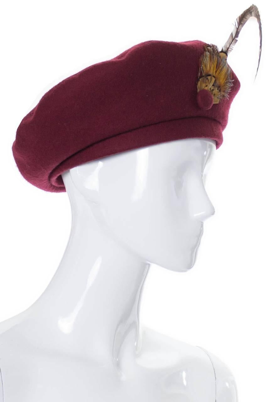 This beautiful Adolfo II vintage hat came from an estate of absolutely incredible mid century  designer vintage clothing and accessories. This wool beret is in a beautiful shade of burgundy and has a lovely feather and covered button that add just