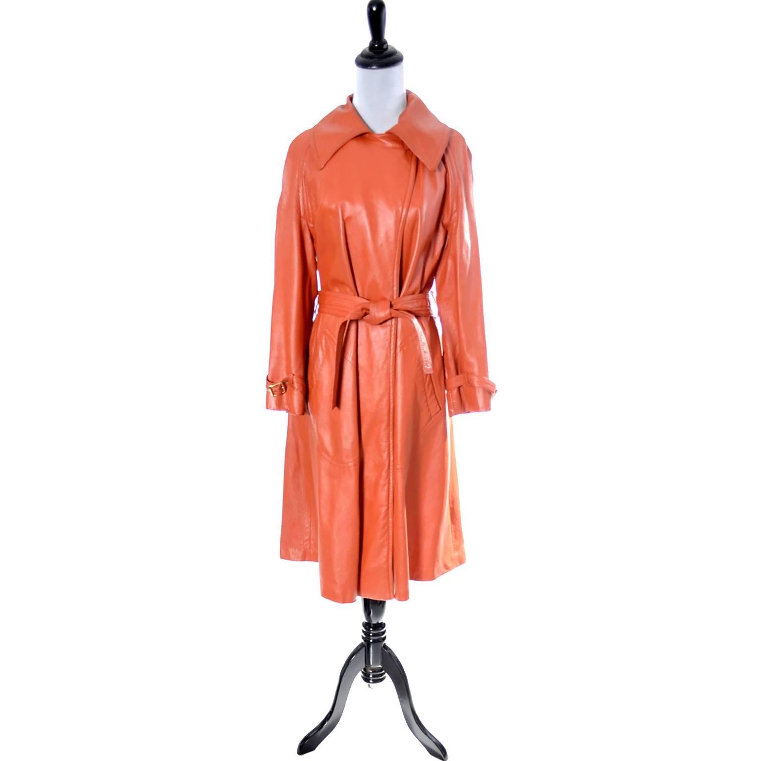 This orange leather Bonnie Cashin coat for Sills is from the late 1960s or early 1970s. It comes with its original belt, has great front slit pockets, is fully lined and has buckles on the sleeves and one to close the neck as shown in the photo. 