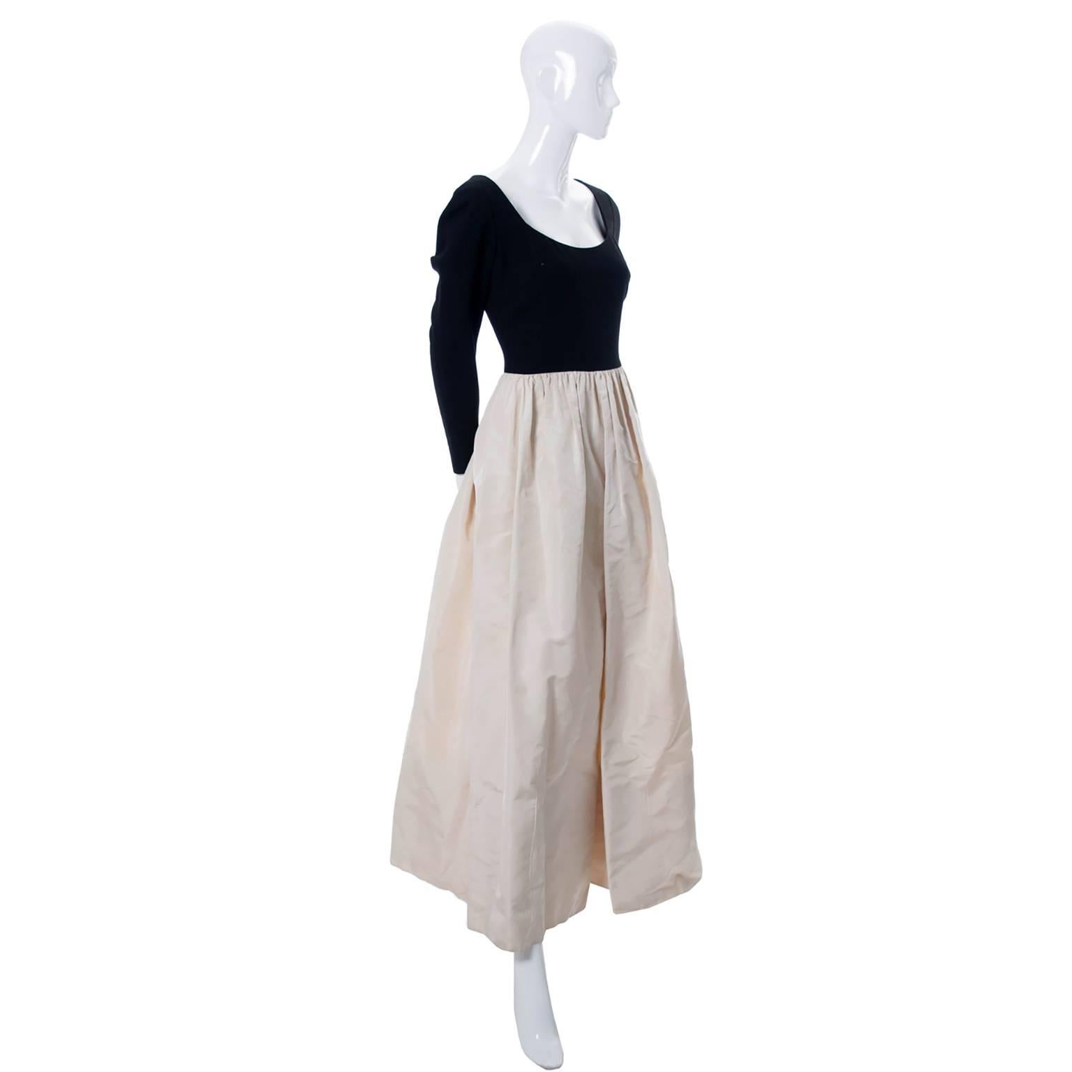 This is a really lovely vintage Pauline Trigere long dress from the late 1960's or early 1970s. The dress has a black wool crepe bodice and a silk satin skirt.  This dress is in excellent condition and has both the Pauline Trigere and Marshall Field