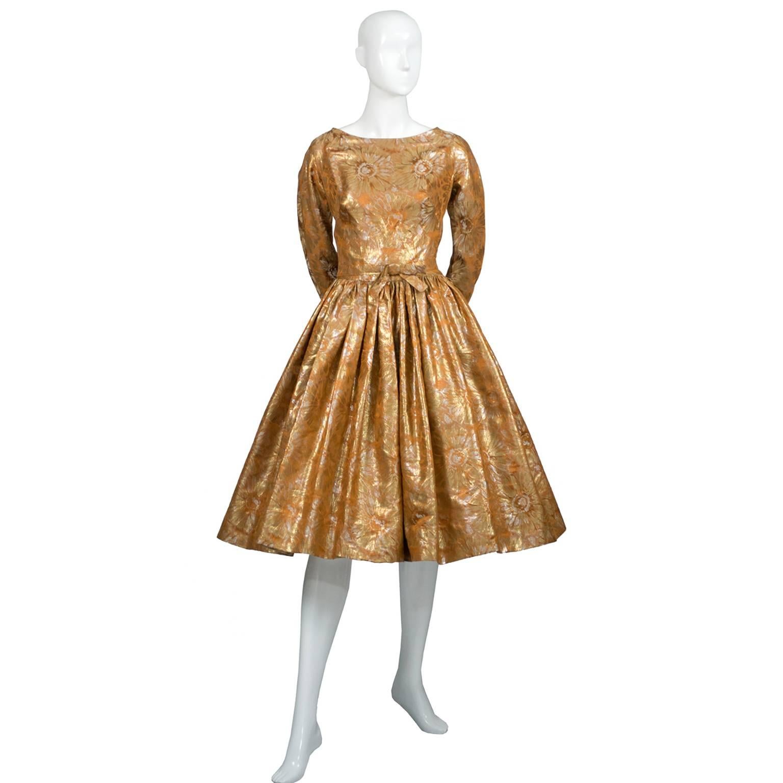 This is a dazzling copper and gold lame floral brocade vintage dress with splashes of orange. This fabulous metallic dress was purchased at Isabell Gerhart, a high end woman's boutique in Houston, Texas in the late 1950s or early 1960's. The dress
