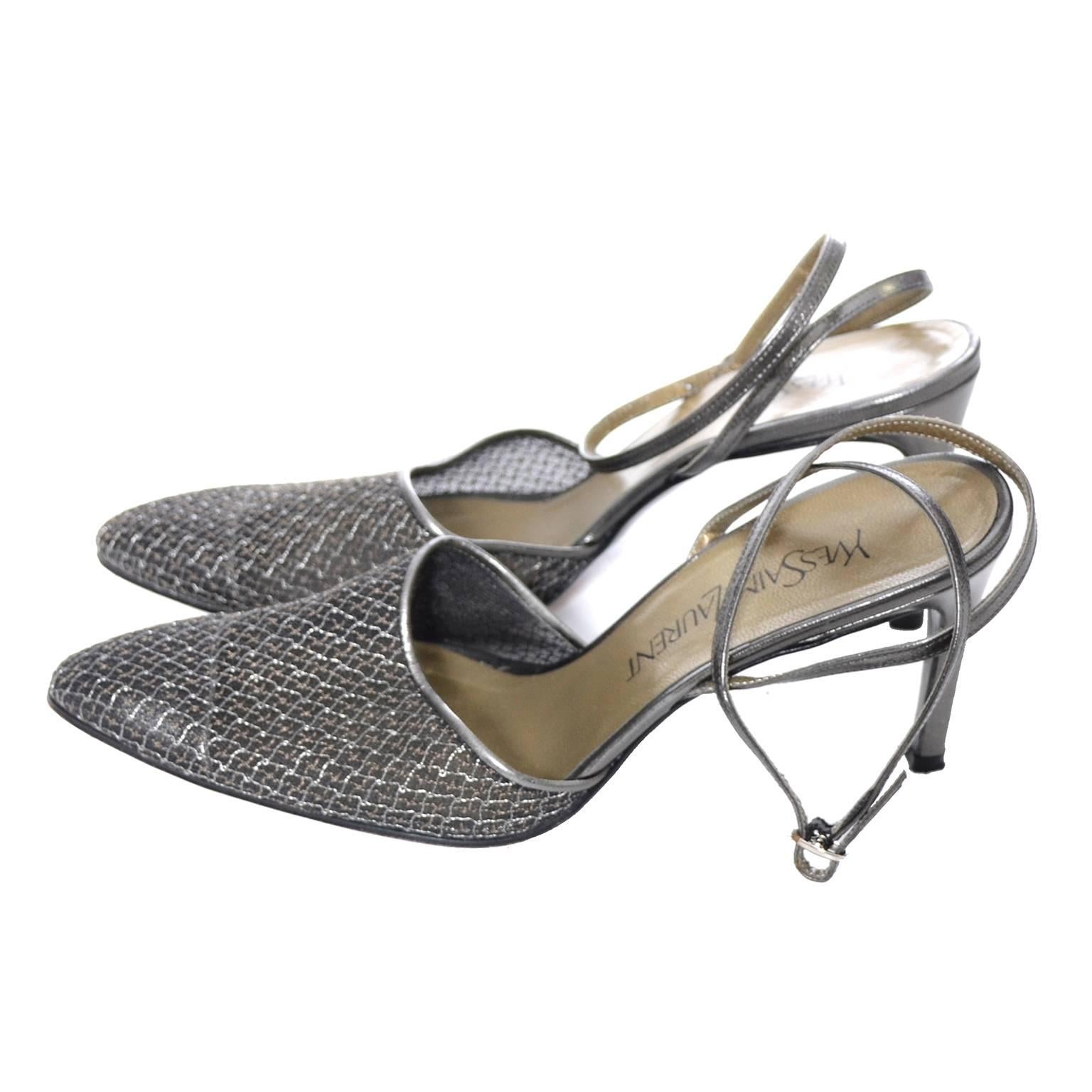 Pretty mesh ankle strap heels from Yves Saint Laurent. These shoes have only minor sole scuffs to indicate they've been worn - made with pretty pewter mesh and smooth leather.  They are marked a size 7.5 M and measure just under 3 inches at the
