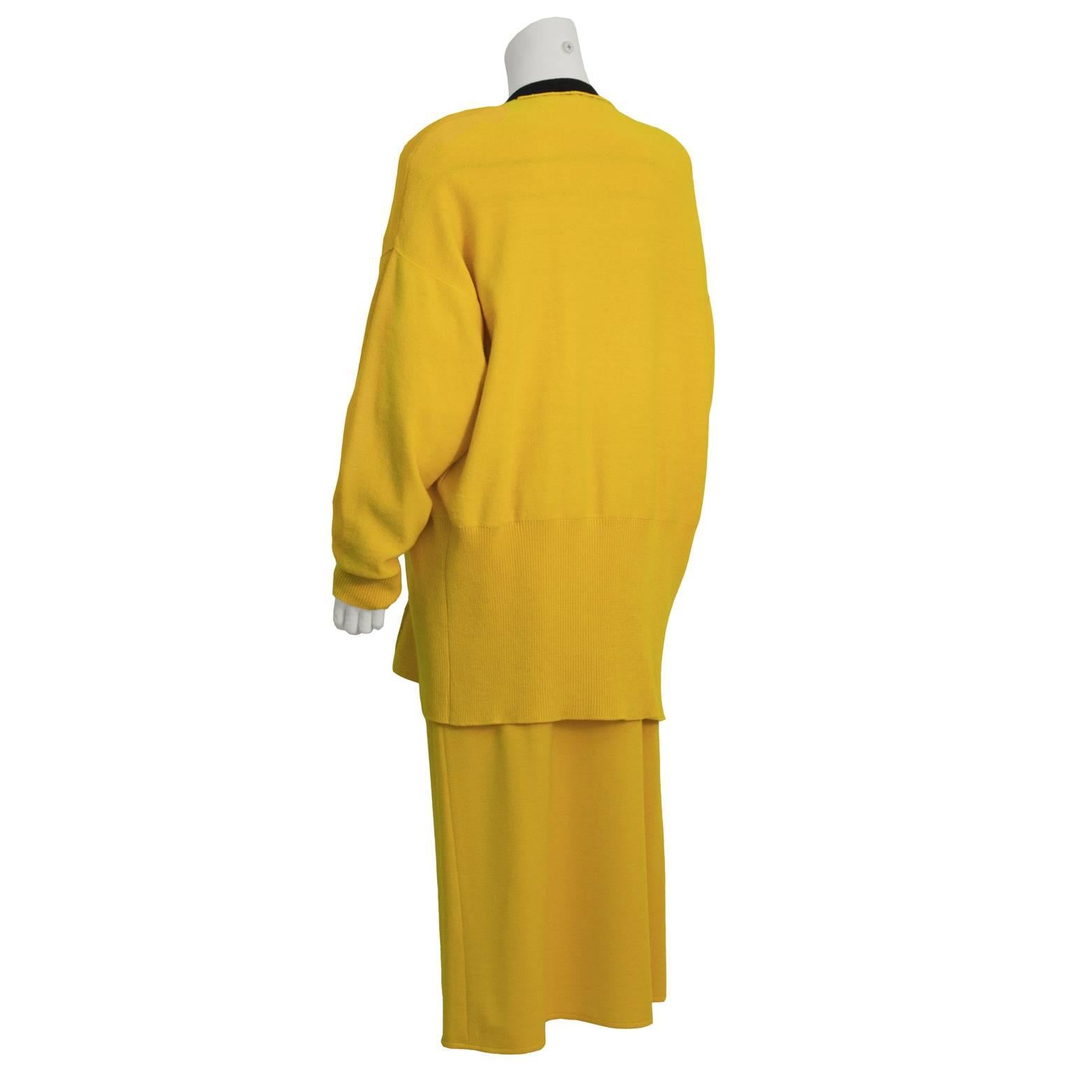 This brilliant three piece Sonia Rykiel ensemble from the 1980's features a pullover sweater, cardigan and mid-length skirt, all in a fabulous vibrant yellow. Pullover has horizontal stripes in black, red, white, and green. Wool knit cardigan