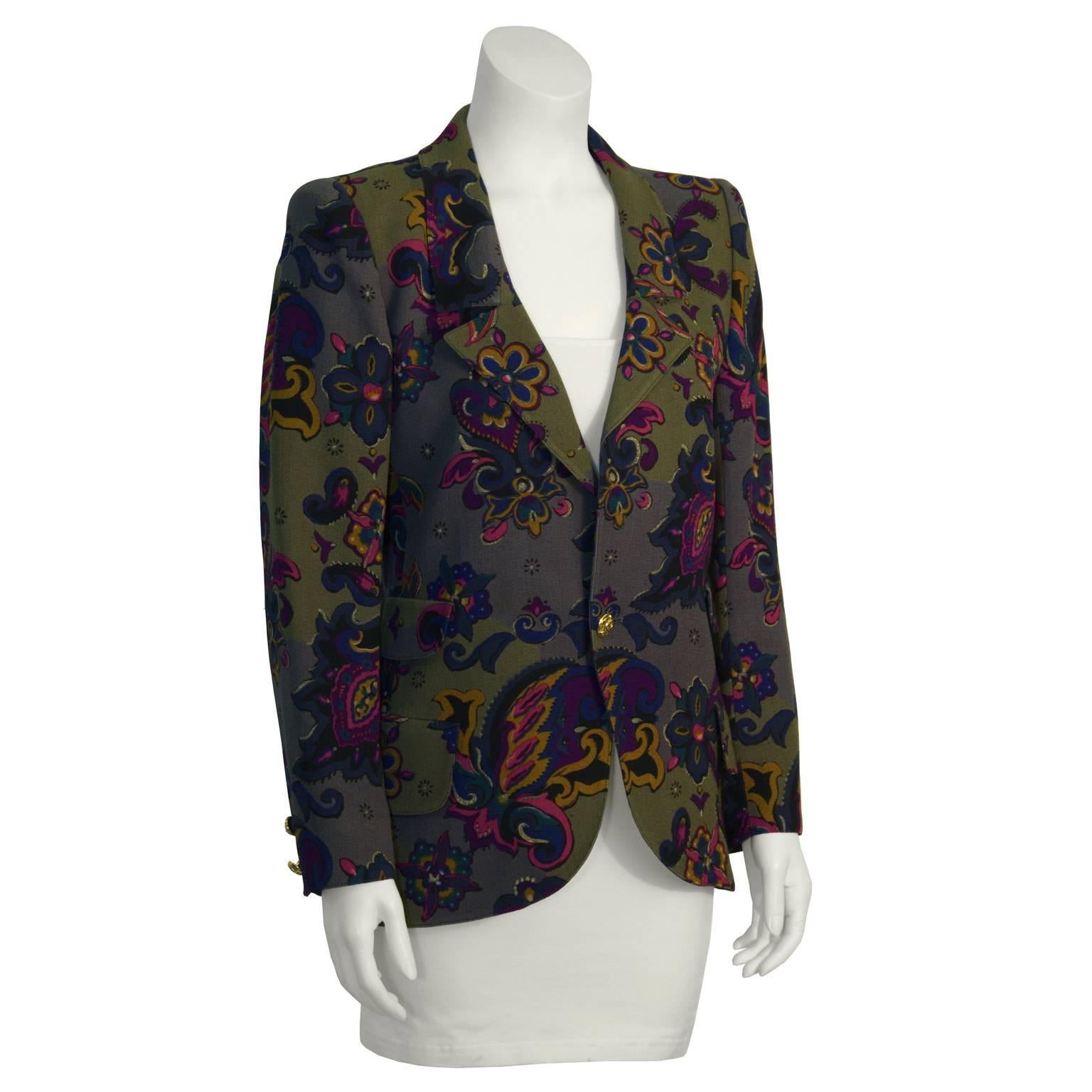 Funky Ungaro khaki floral blazer from the 1980's featuring notched lapels, a single button closure and two patch pockets at the hip. Gold plate button with ornamentation. Paisley print has notes of magenta, purple, teal and mustard. Amazing way to