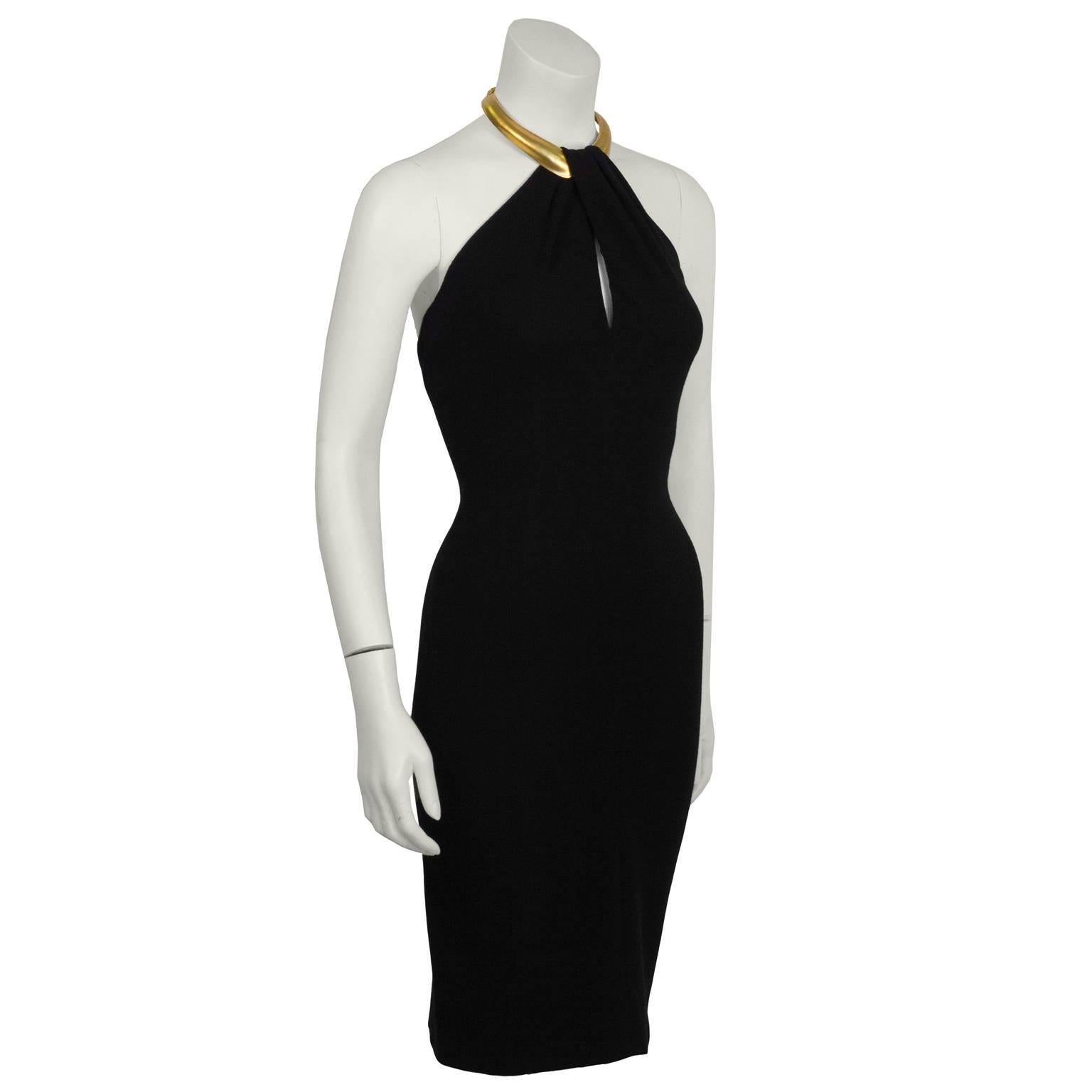 This Donna Karan black halter mini dress from the early 1990's is the ultimate sexy LBD. The stretch fabric body con dress features a matte gold Robert Lee Morris choker with a chain clasp, and a key hole slit. Excellent vintage condition. US size