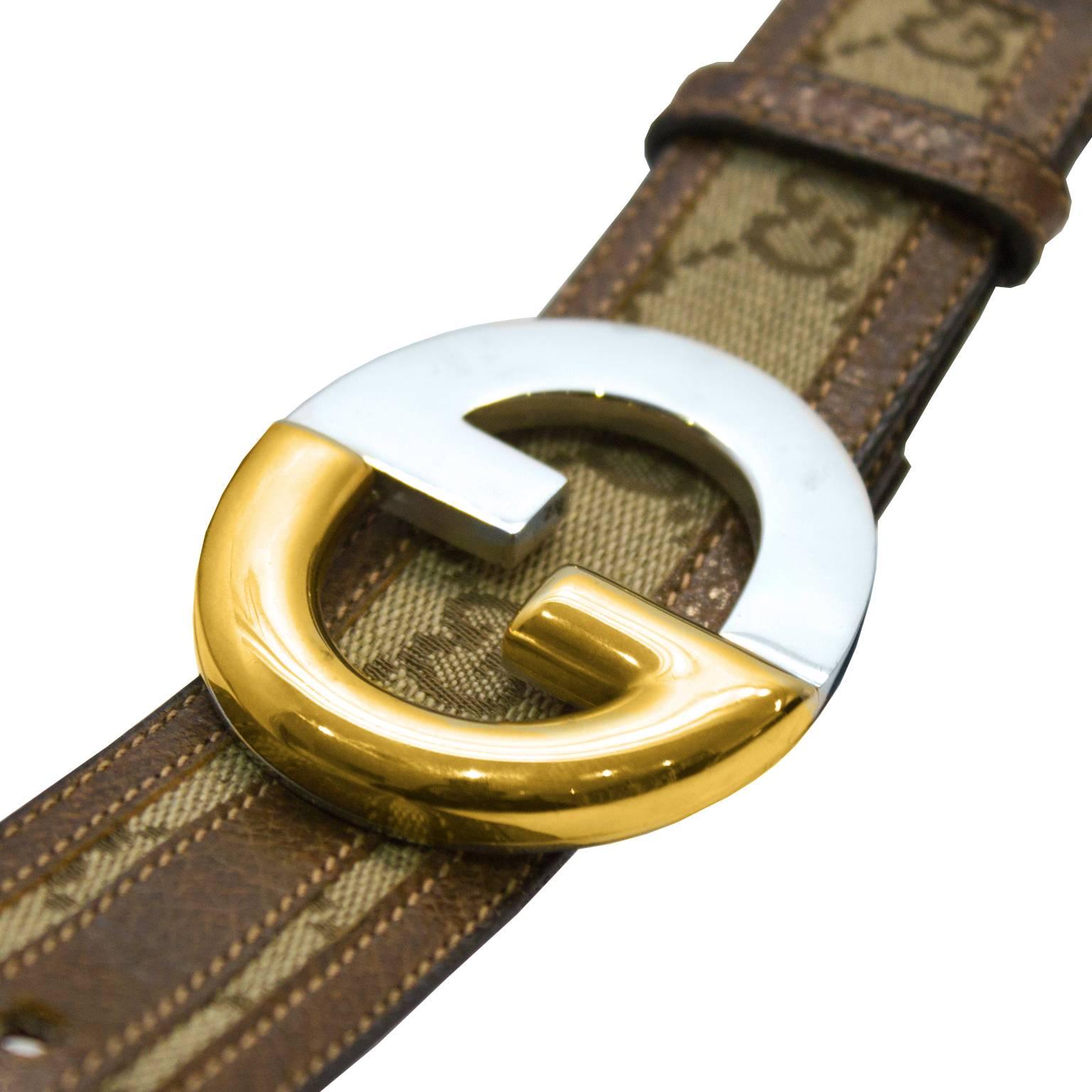 Classic Gucci canvas monogram belt from the 1970's featuring it's iconic print throughout, a GG belt buckle in goldtone and silver metal and a brown leather interior. Excellent vintage condition.
