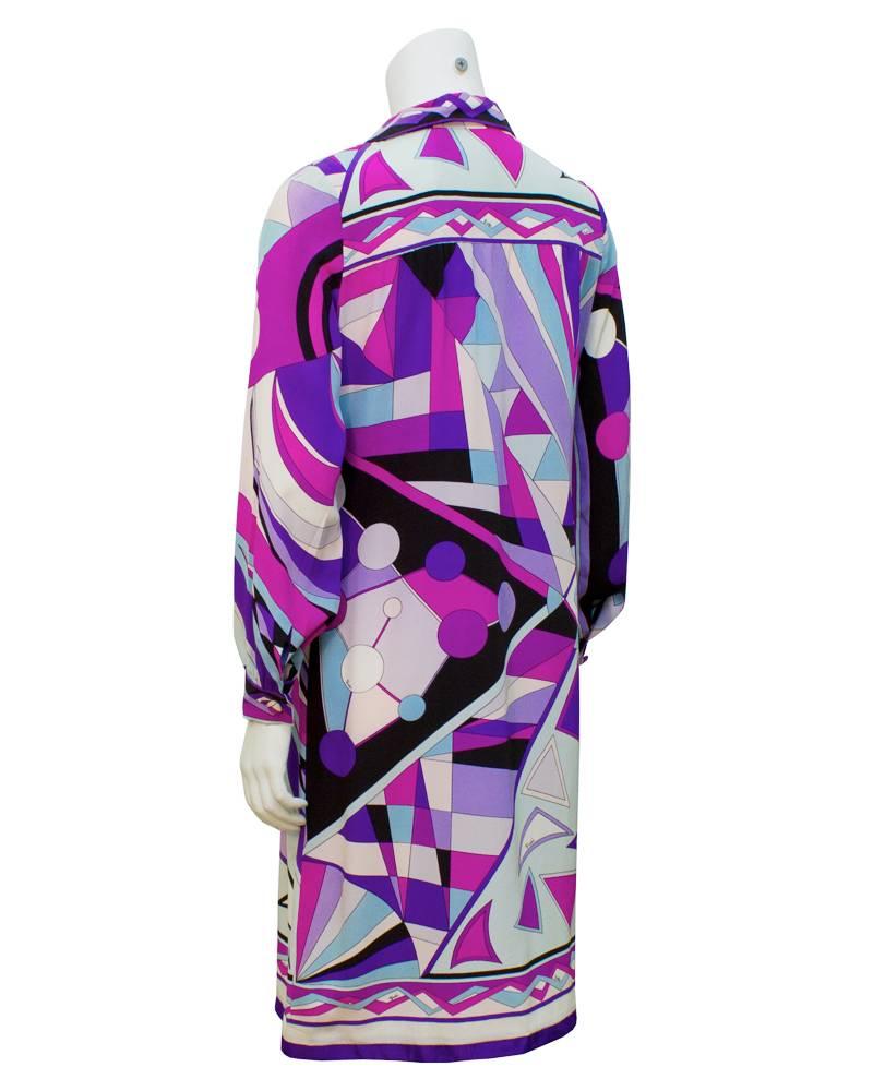 1970's scarf silk Pucci dress that fits true to US size 6. Bold purple, shades of blue, pink and black geometric pattern on white background. A-line fit with border detail at hem and across the yoke. In excellent condition. 