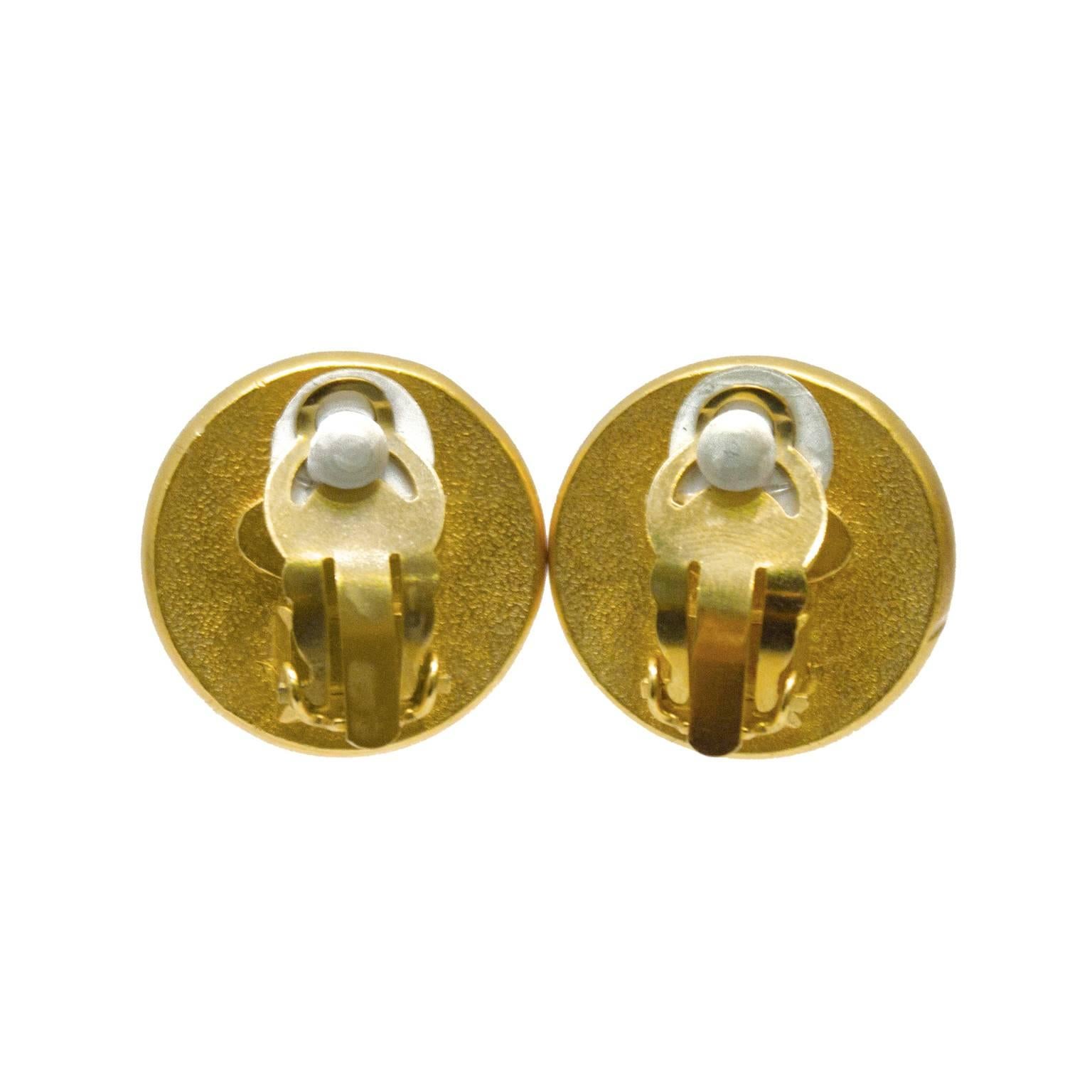 Chanel pearl clip on style earrings from the 1993 Fall collection. The earrings feature a faux pearl center surrounded by a smooth border stamped with CHANEL PARIS. In excellent condition. 