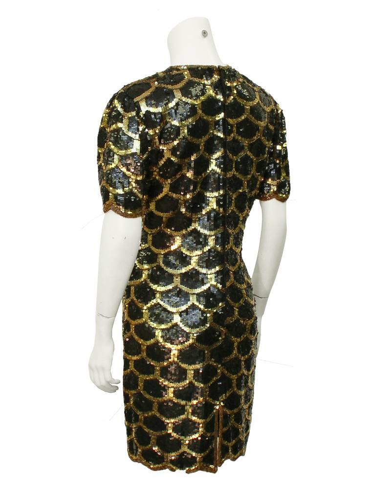 1970's American made adorable and timeless sequin fish scale pattern mini dress with scallop edged short sleeves. Fitted through the waist, shimmery like a mermaids tail. In excellent condition, the ideal LBD with a twist. Fits like a US size