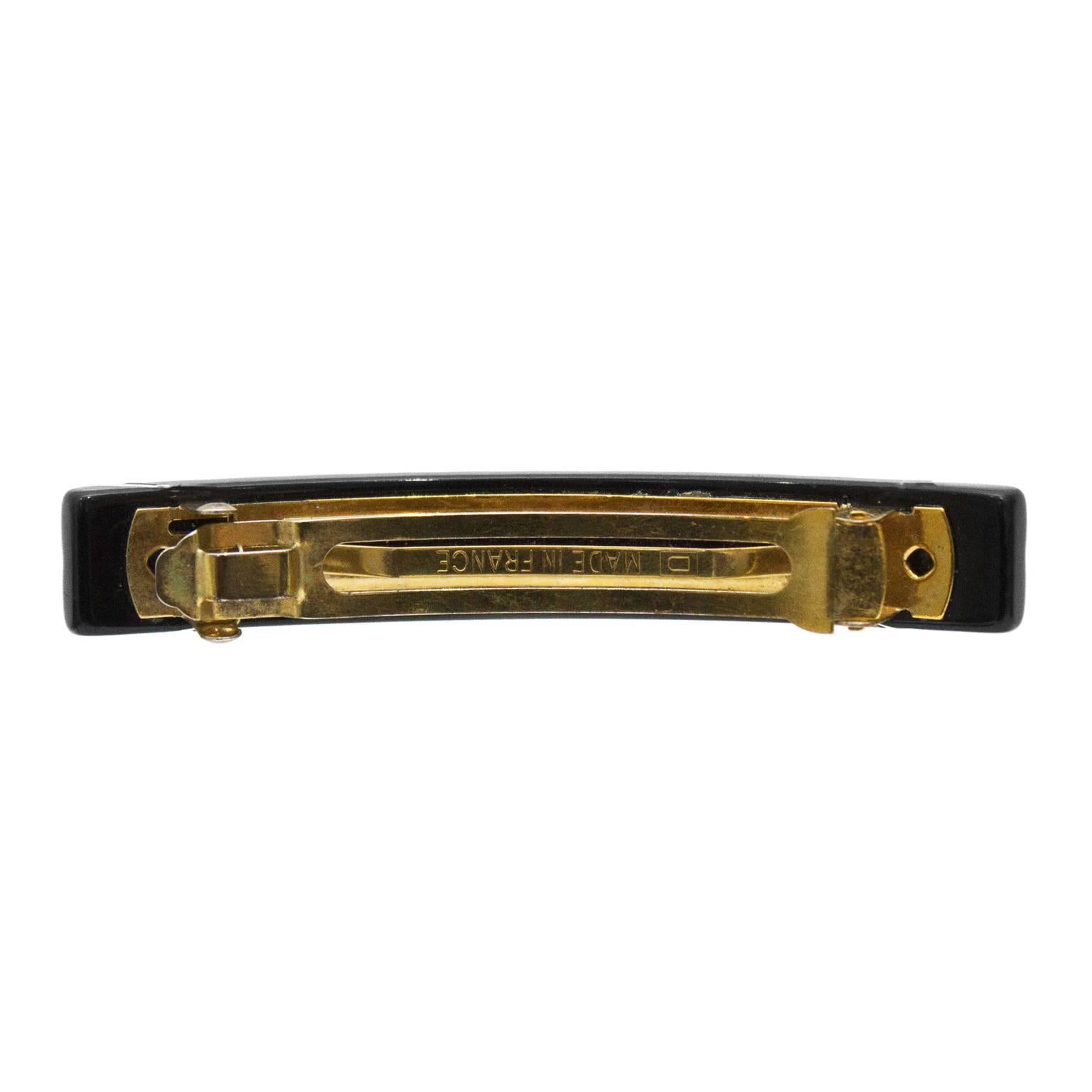 Chanel black quilted effect plastic barrette from the early 2000’s. The quilted surface features 6 mini gold CC’s at the center row. Finished with goldotne hardware. In excellent condition. 
