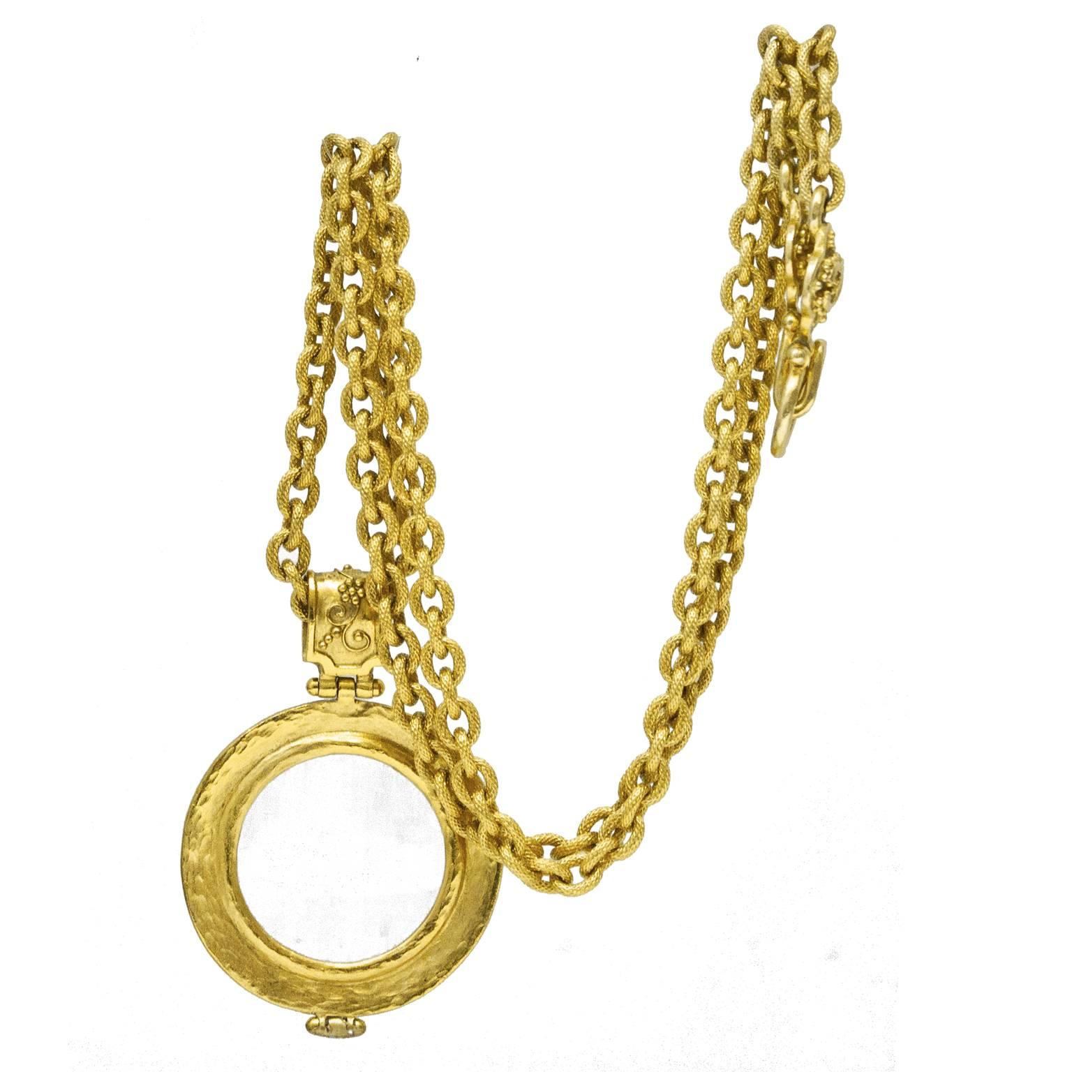 Chanel gold tone loupe from the autumn 1995 collection. The textured chain link necklace features a magnifying glass pendant decorated with grape and flower filigree around the edge. Double CC decorated hook clasp. Signed on the clasp. In excellent