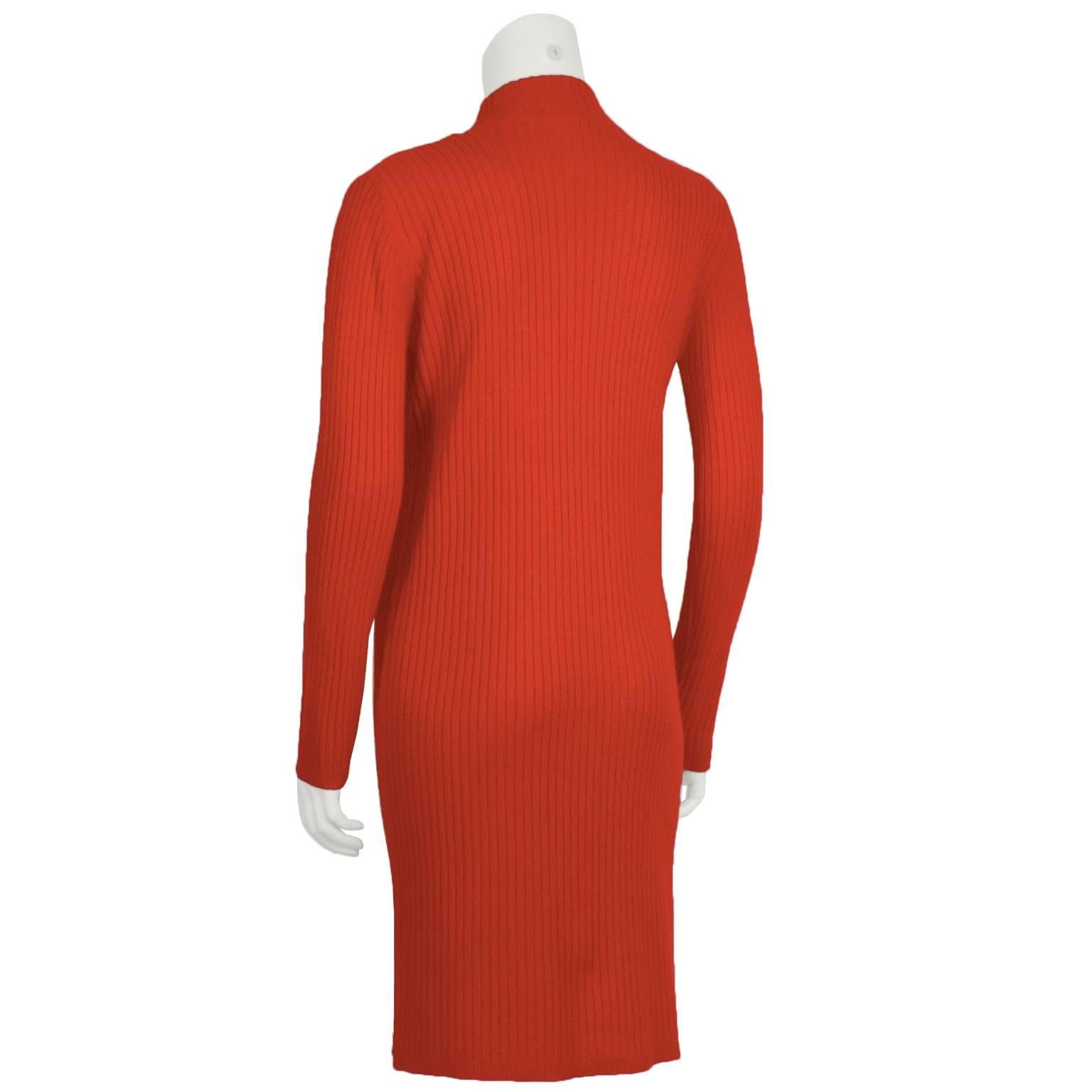 Courreges 1980’s ribbed wool mock turtleneck sweater dress. A classic Courreges style reissued 20 years after the first iconic RTW space age knits hit the runway. Courreges signature white embroidered logo sewn on below the mock turtle neck. In