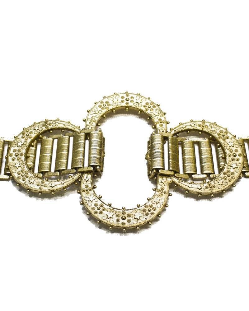 Gold plated link belt in a style often associated with imported Middle Eastern artifacts and accessories in excellent condition. Features rectangular links with crescent details meant to be worn at the front. Made in the 1960's. Not adjustable.