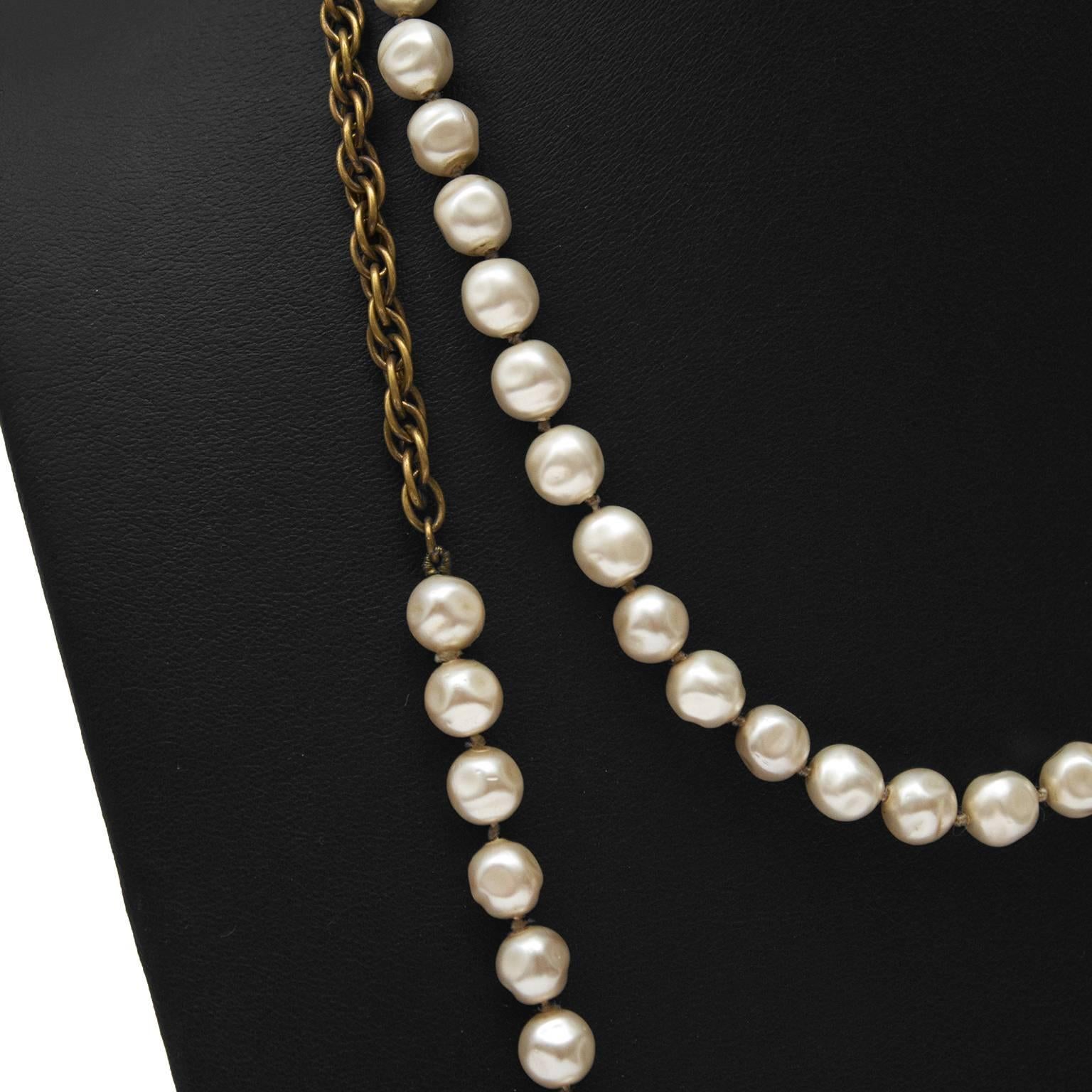 Chanel faux pearl and gold chain necklace from 1983. Two sections of white pearls along with two sections of french rope style chain make up this beautiful necklace. Long enough to be worn doubled. Octagonal tag attached marked CHANEL 1983. In
