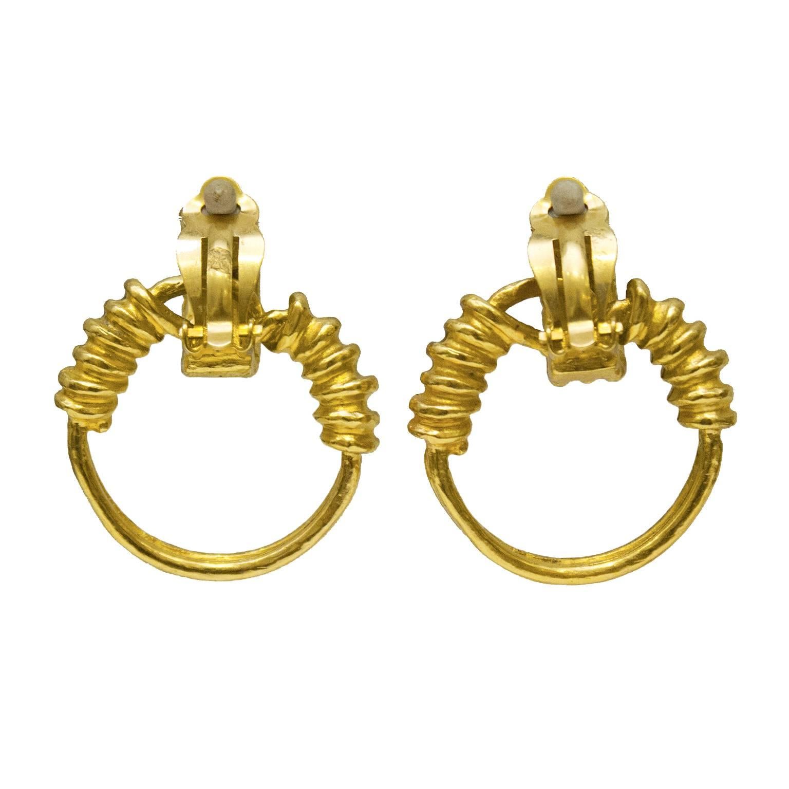 Goldtone Chanel hoop clip on style earrings from the 1994 Spring Collection. Half moon clips with a small CC on the front, attached hoop dangles from the top clips and have a wrapped detail. In excellent condition. 

1.5