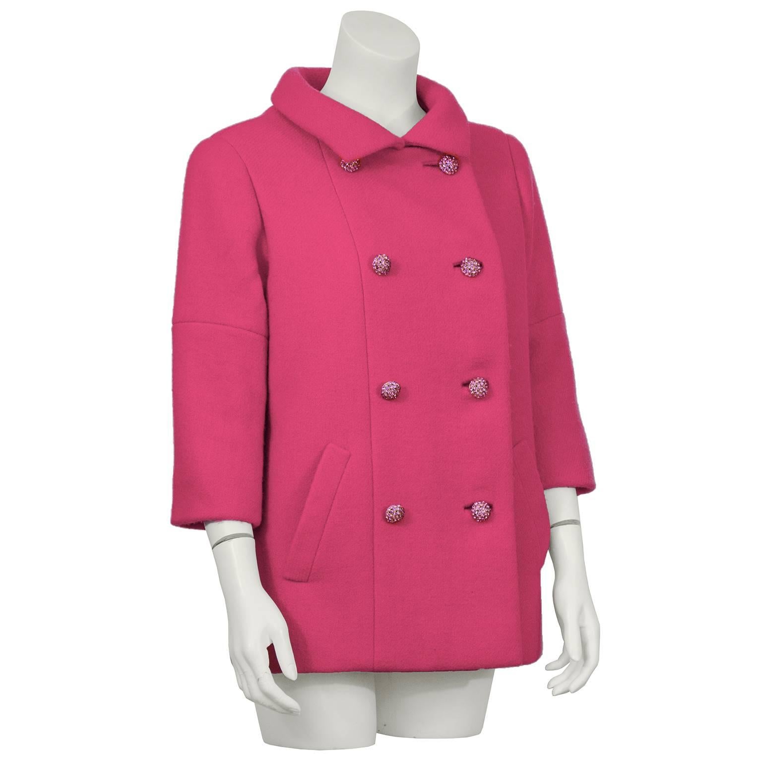 1960's Norman Norell shocking pink wool double breasted pea coat. An amazing example of Norell's talent with simple classic shapes. The pink rhinestone buttons, the heavily stitched seams, slash pockets and the bracelet  length sleeve take this from