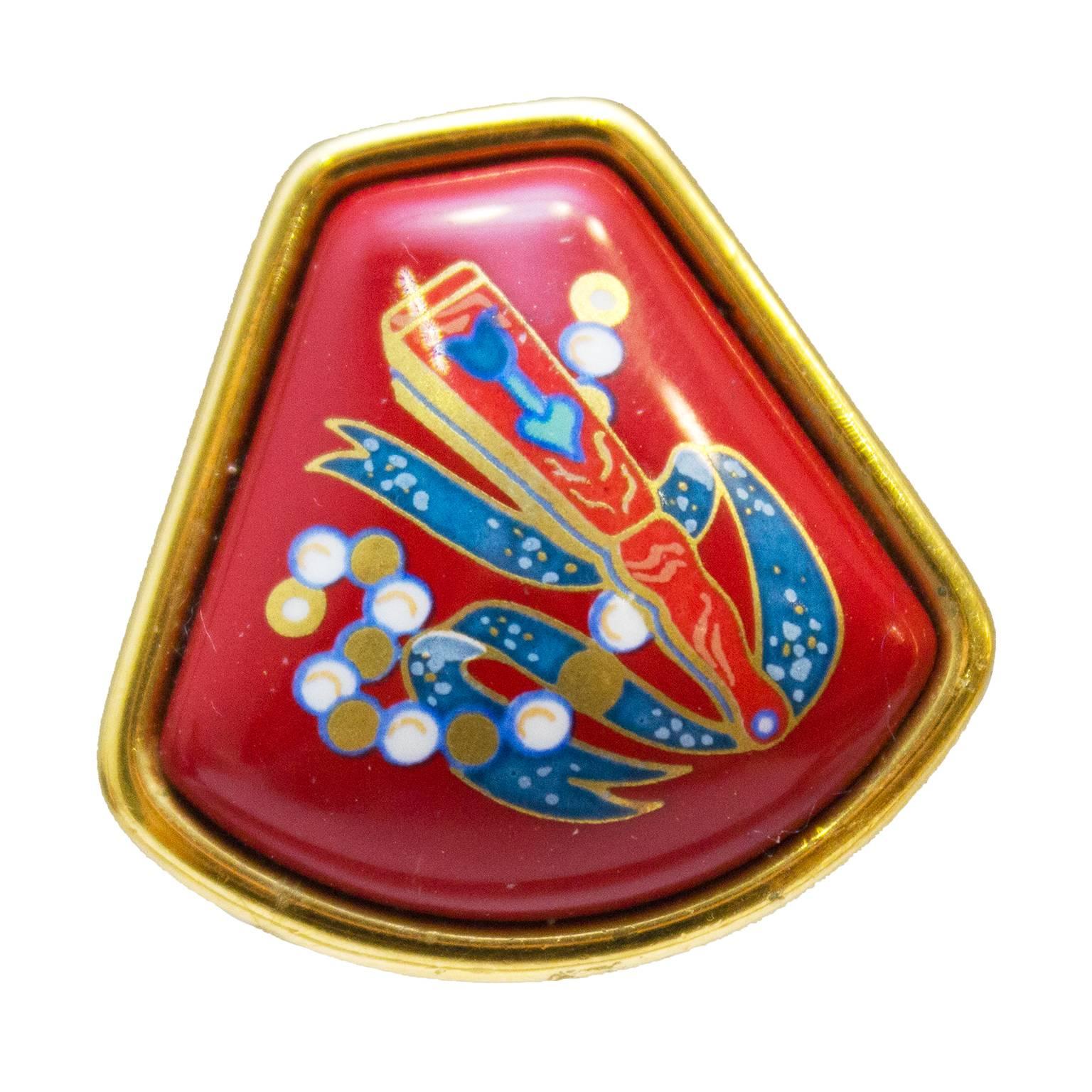 Elegant enamel clip on earrings from Hermes circa 1980. Signed on the back with the Hermes stamp. Modern fan shape with vibrant red enamel background featuring blue, gold and white Asian inspired imagery. In excellent condition. Medium size.

1in