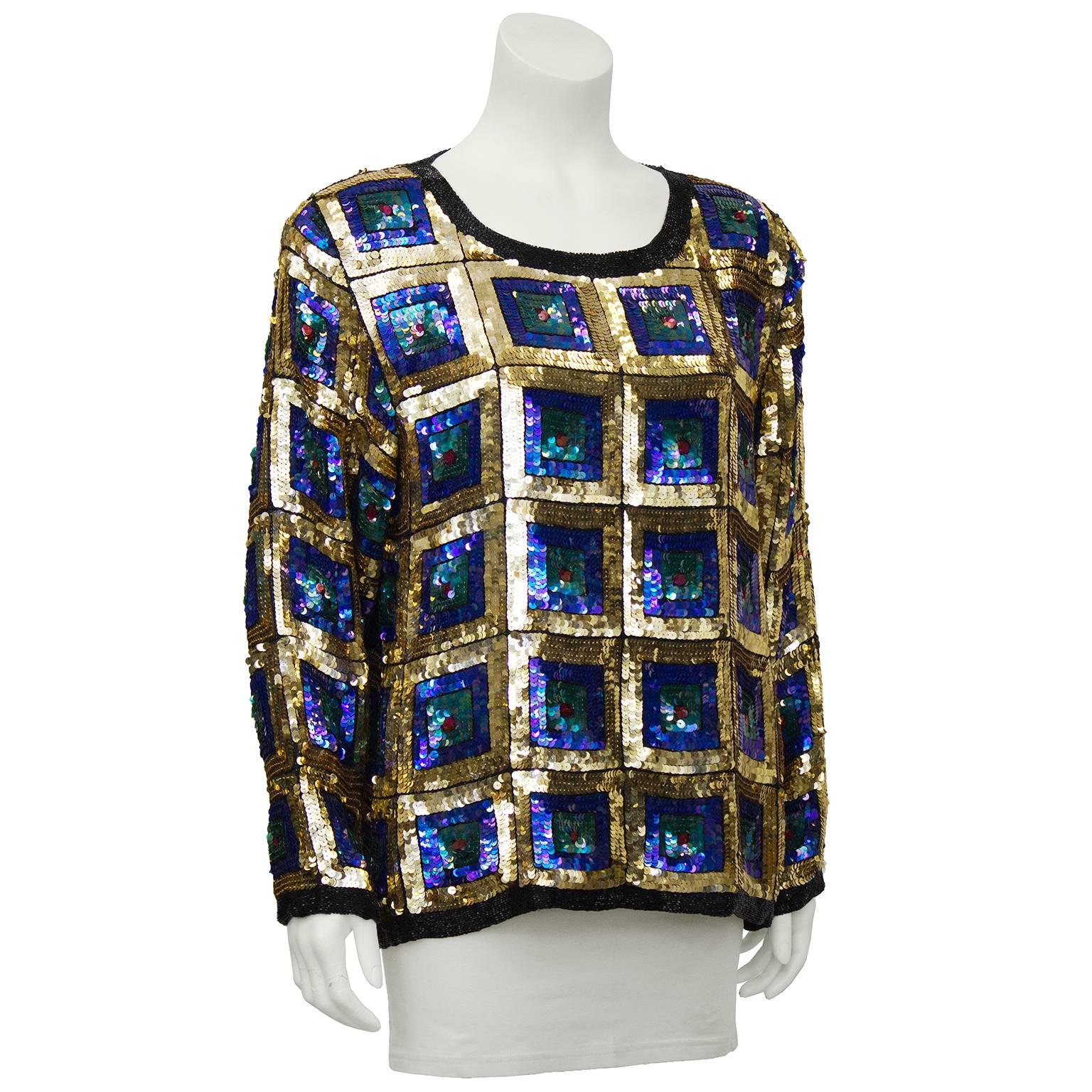 So hard to resist 1970's hand made in India gold sequin on chiffon pull over top. Square pattern with inset iridescent blue sequins outlined in black. In excellent vintage condition. Fits like a US 6.

Shoulder 19