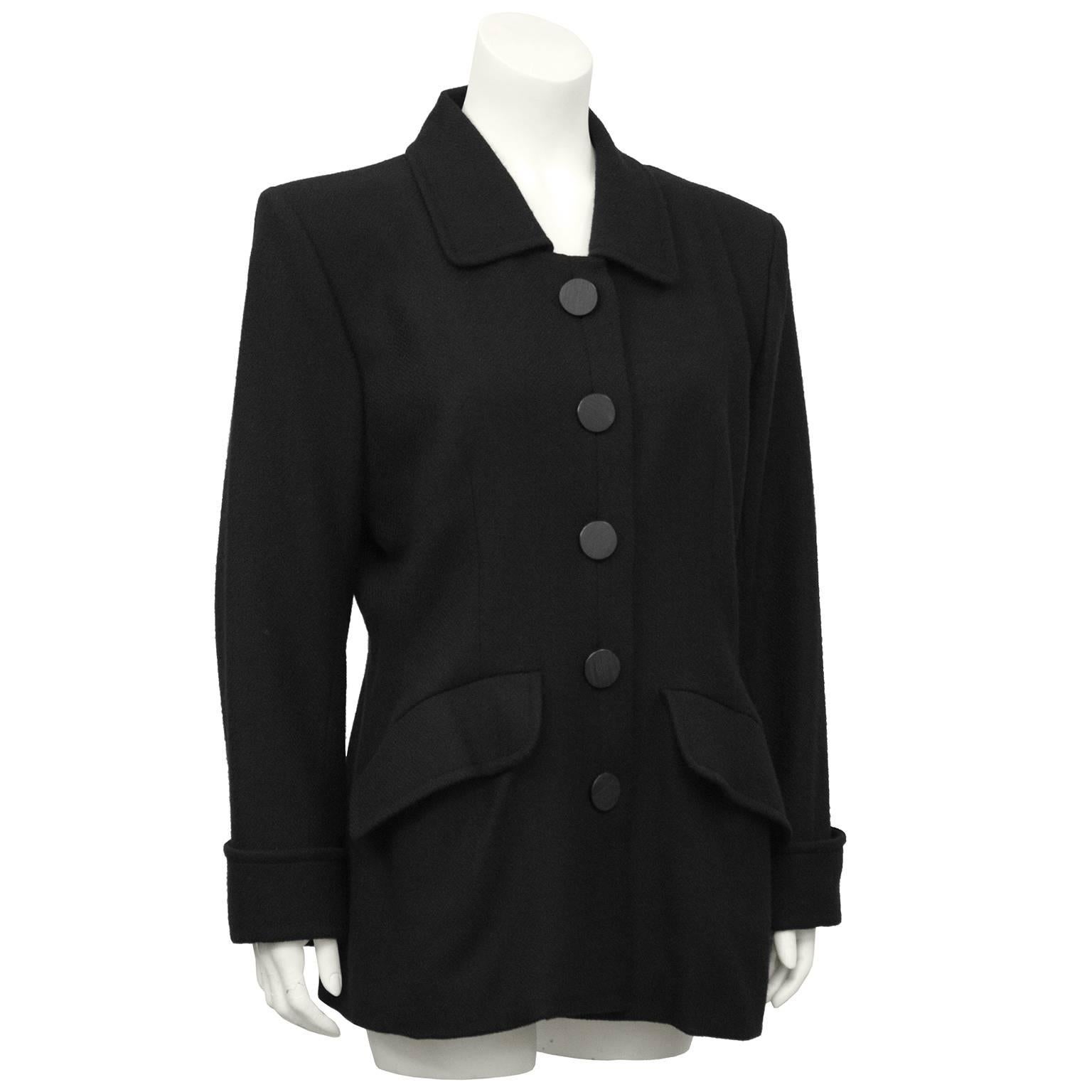 1980's Yves Saint Laurent black cashmere and wool blazer with large flat black buttons and chic oversized pockets fitted through the waist. Classic blazer that can be worn casually, or dressed with skinny jeans and killer black pumps. Excellent