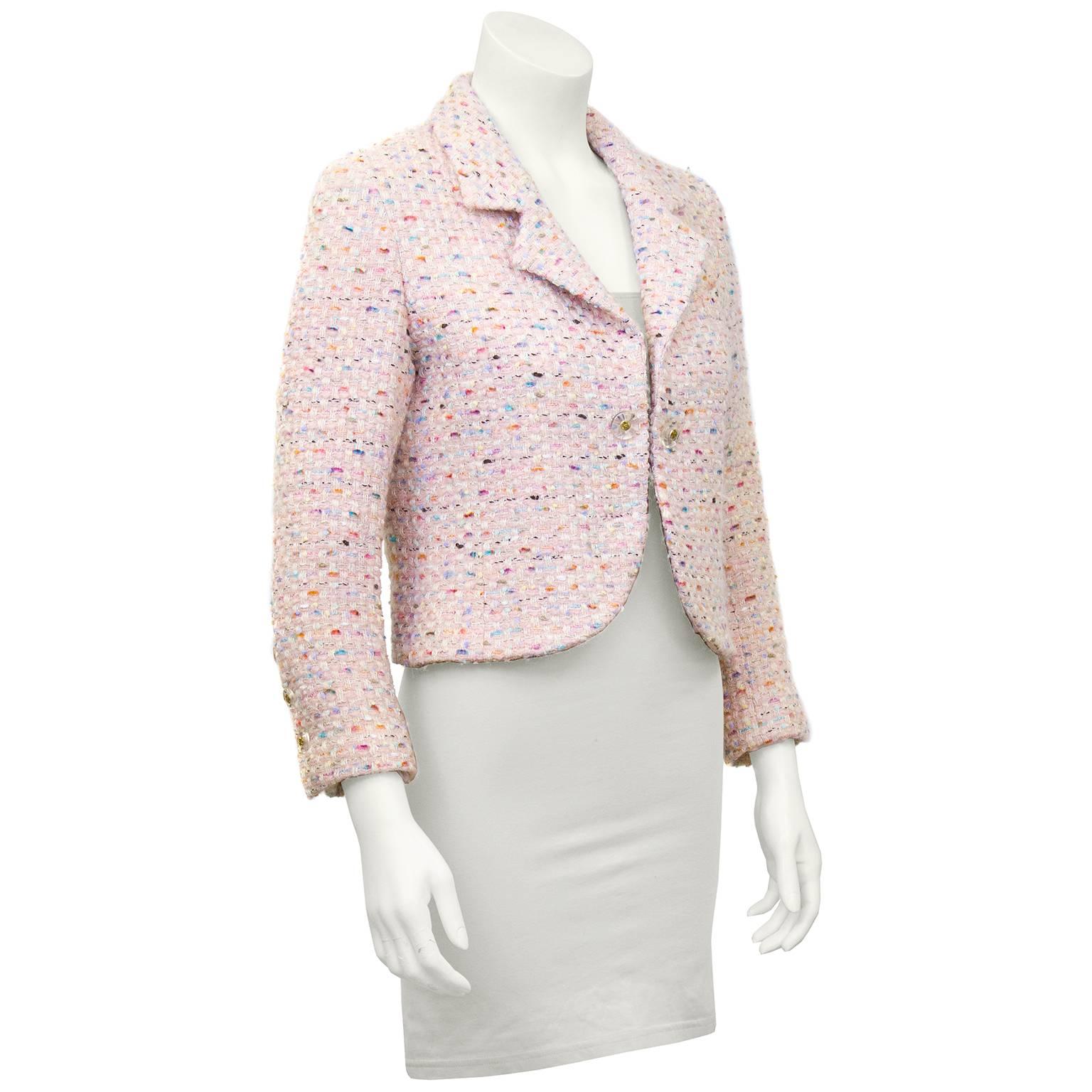 Cute and chic 1994 spring collection Chanel jacket in a beautiful boucle with shades of pink, orange, blue, and purple. Cropped with stunning lucite and gold CC buttons at front closure and wrists. The classic Chanel jacket in a fun and updated