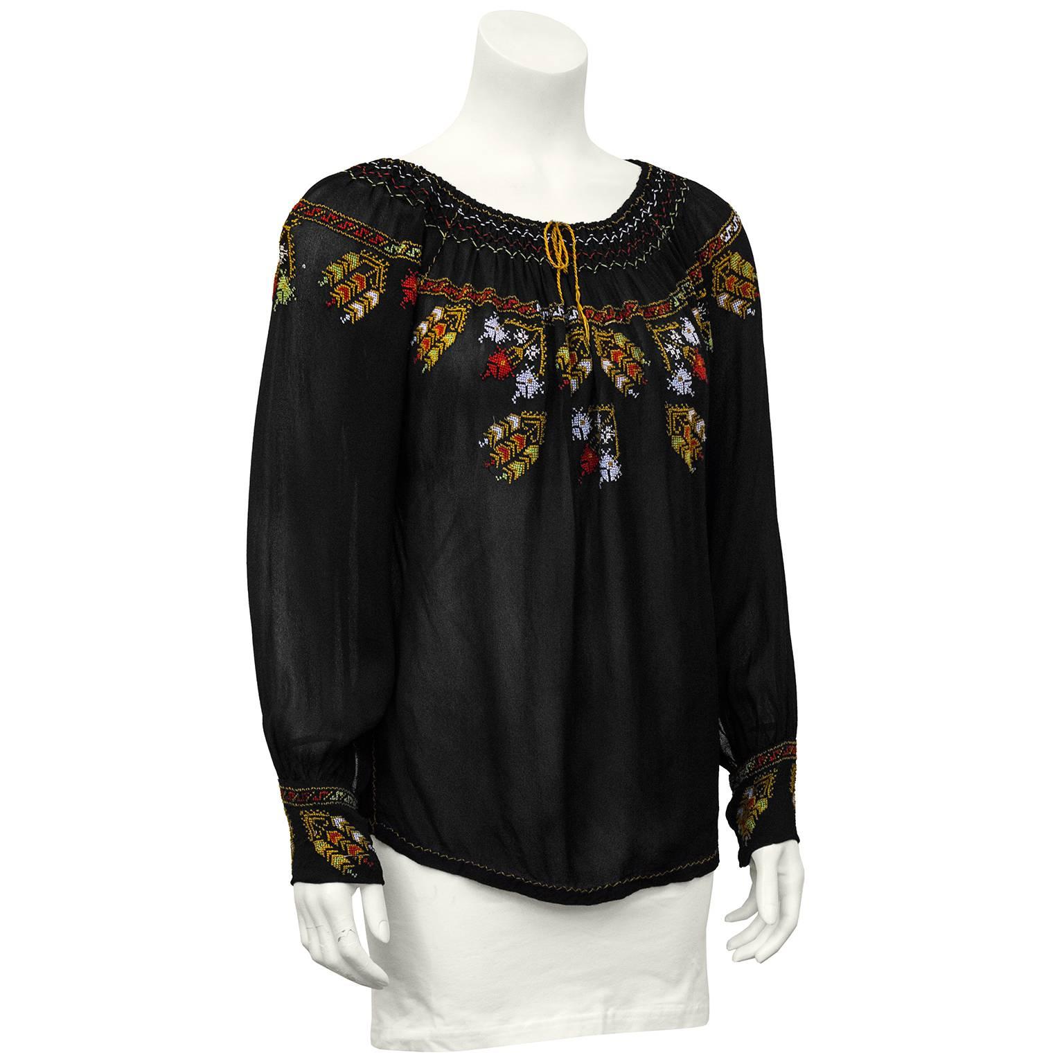 Gauzy 1940's black long sleeve smock top with stunning Bohemian folk style hand embroidery at neckline, bust and wrists. Drawstring at neck line, can be worn on or off the shoulders. In excellent vintage condition, fits like a US 4. 

Sleeve 16.5