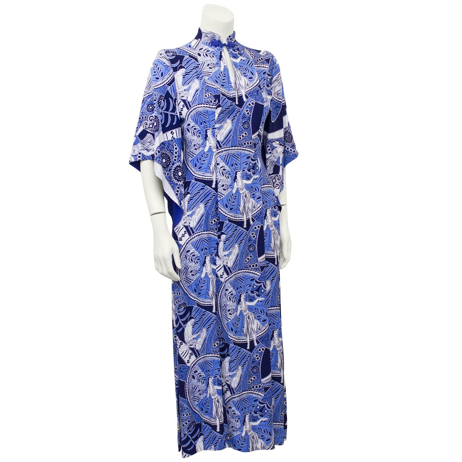 Bold periwinkle blue, black and white rayon 1940's hostess gown printed with Hawaiian ethnographic motifs. Mandarin collar with interesting Asian influenced knotted closure and keyhole, open trumpet shaped flowing asymmetrical sleeves. Very unique