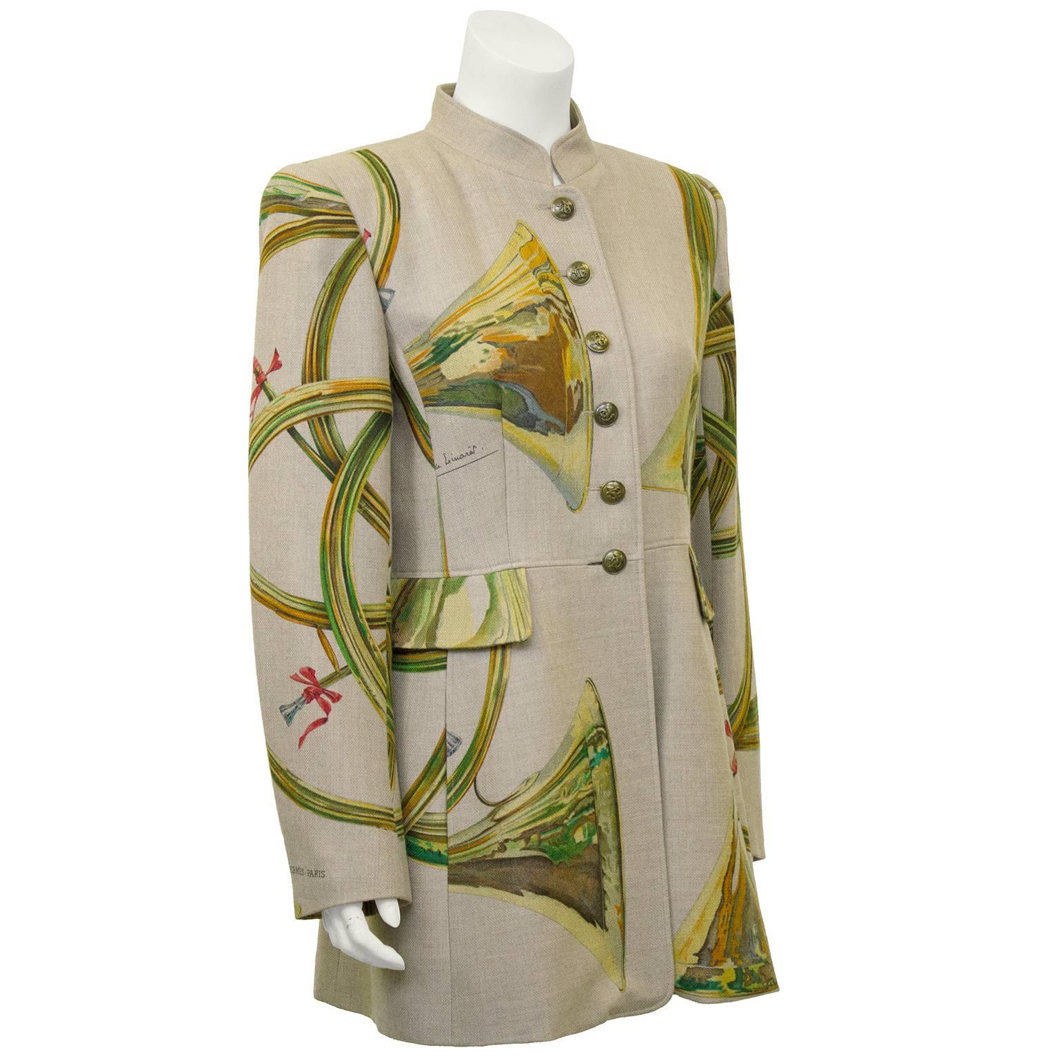 Stunning long fit military style Hermes jacket. Beautiful shape, stunning earth tone trumpet print with small pops of pink and Hermes marking stamped on sleeve. 80% wool, 20% cashmere. Beautiful brass buttons with trumpets corresponding to the