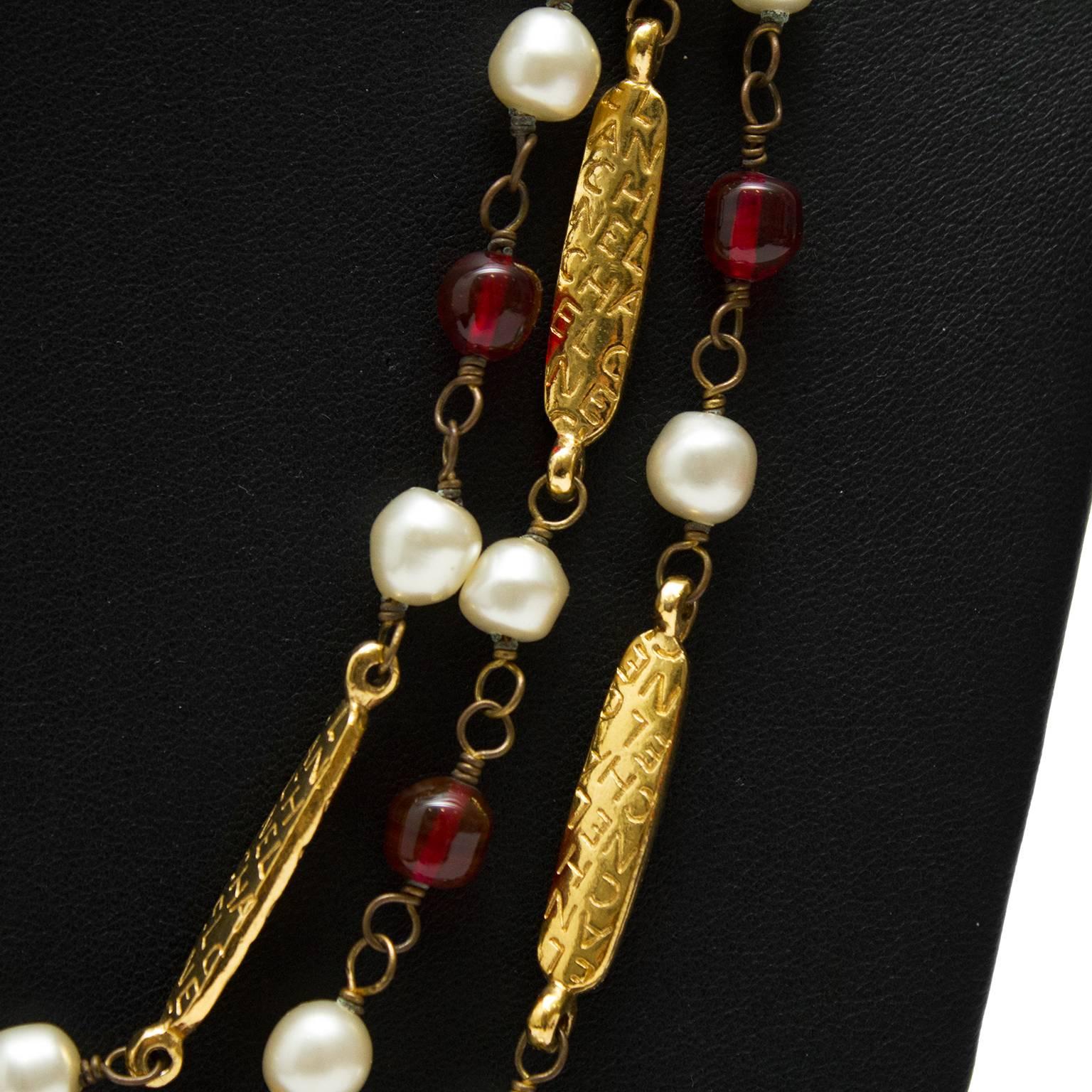 1970’s Chanel long necklace featuring pearls, red poured glass beads and long gold beads with CHANEL stamped repeatedly. Can be worn long or looped many different times. Beautiful piece featuring every aspect that Chanel jewellery is known for;
