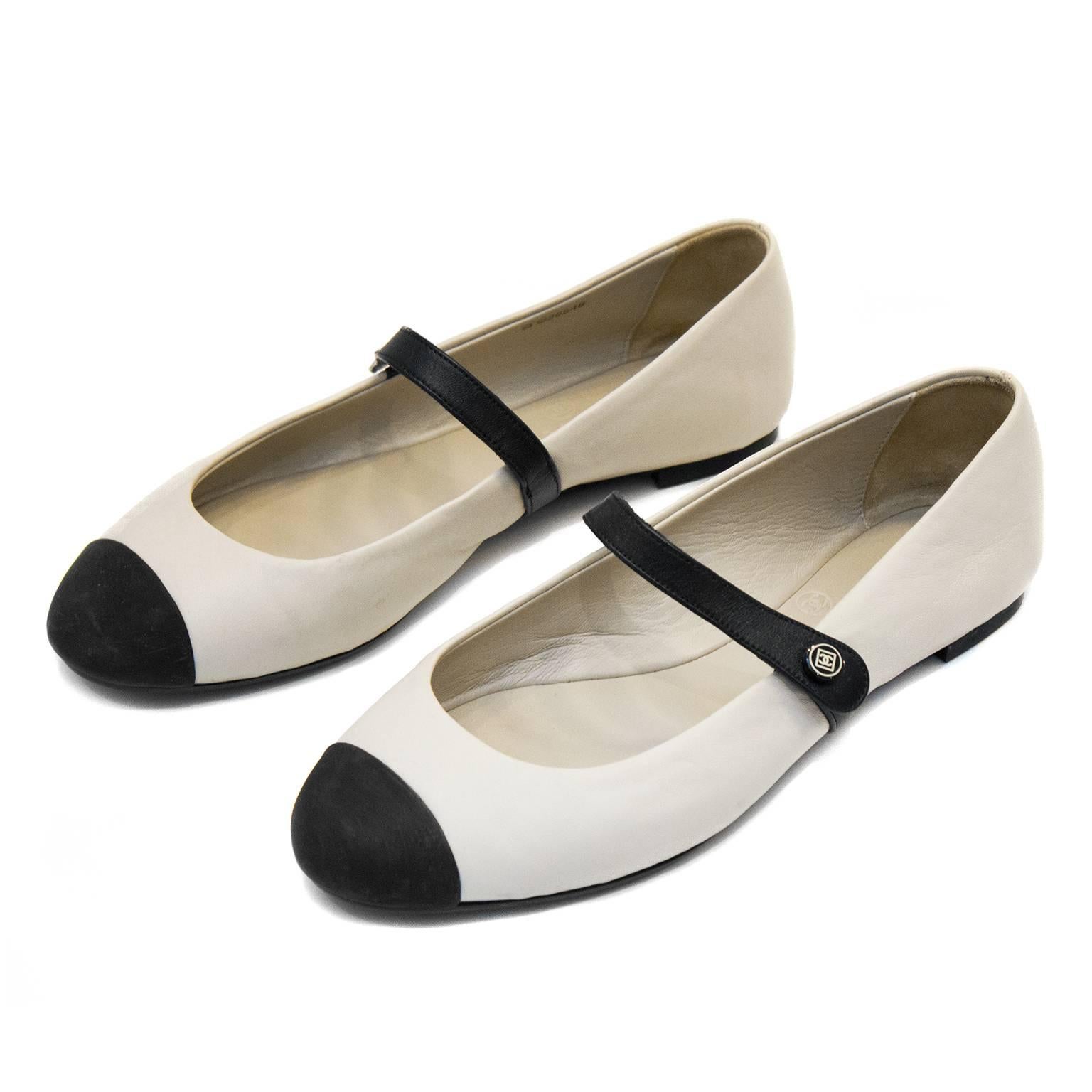 Chanel flat Mary Janes from the 2000's. Cream leather with black cap toe and strap. Chanel markings at heel and at strap button. Matching cream leather interior. Black rubber sole with Chanel markings, perfect for everyday wear. Excellent vintage