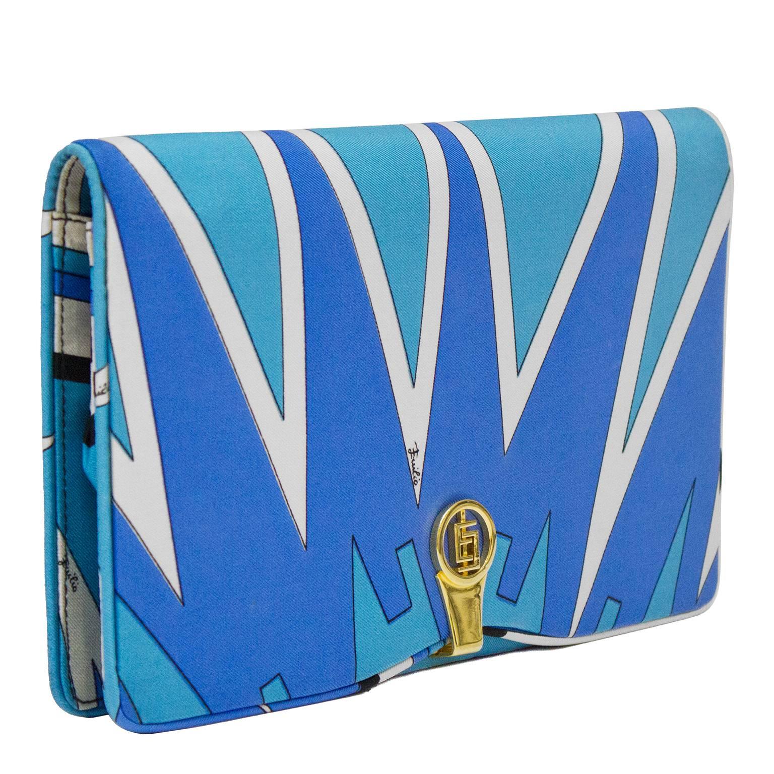 Beautiful 1970's Emilio Pucci silk clutch. Iconic Pucci brand printed and signed fabric in blue and white tones. Gold hardware with interlocking E's. Clean interior with gold stamp. The perfect touch of the 1960's to add to any look. Very good