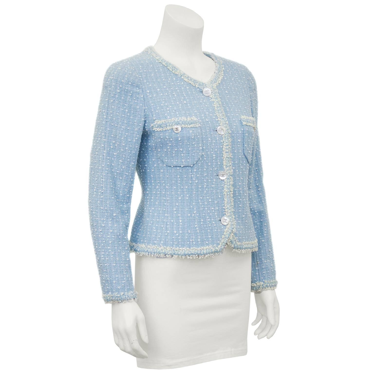 Baby blue and white speckled boucle Chanel jacket from the Spring 1997 collection. White mother of pearl buttons with silver cc logos. Beautiful scooped v-neck and patch pockets and curly cream fringe trim to placket. Beautiful and in excellent