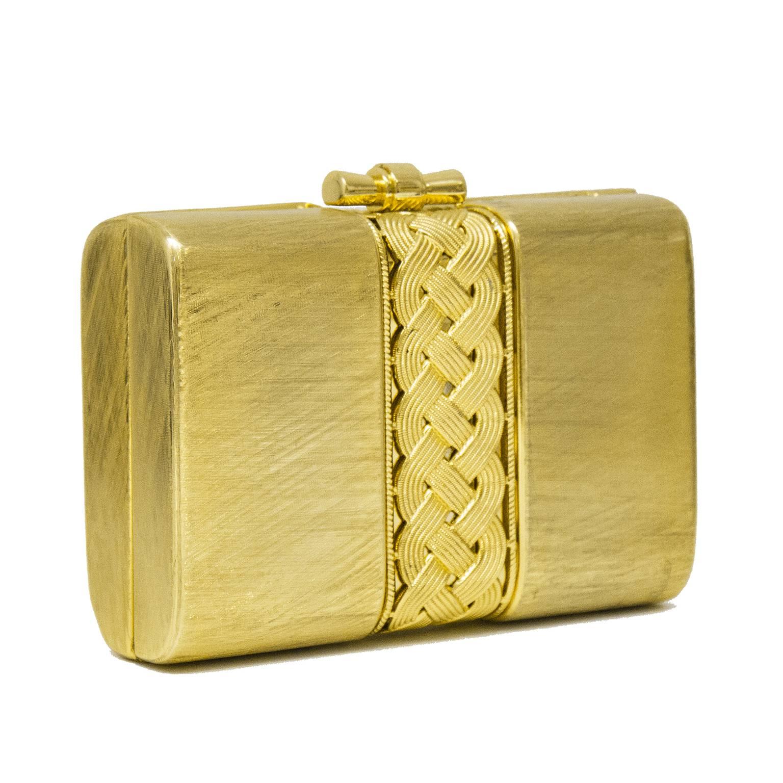1980's Rodo brushed gold tone metal evening clutch. Rectangular, with interlocking braided detail in center. Minor wear to exterior. Clean gold leather interior with small pocket. 23