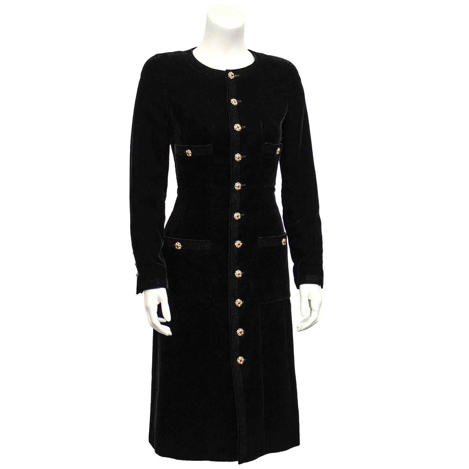 Really beautiful Chanel jet black velvet dress from the Autumn 1996 collection. Long sleeve and mid calf length. Detailed with 11 original poured glass buttons with various jewel tones. Matching buttons on the four pockets, 2 at bust and 2 at hips.
