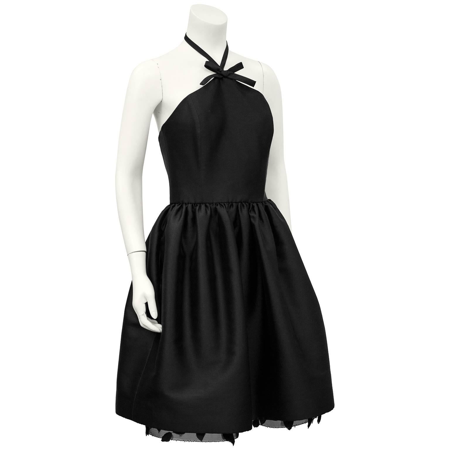 Adorable 1990s Bill Blass Black silk taffeta dress. Halter neck with bow detail, tight bodice and gathered skirt. Black crinoline under skirt with black silk taffeta cut in the shape a small leaves. Excellent unworn condition. Retailed for $2250.