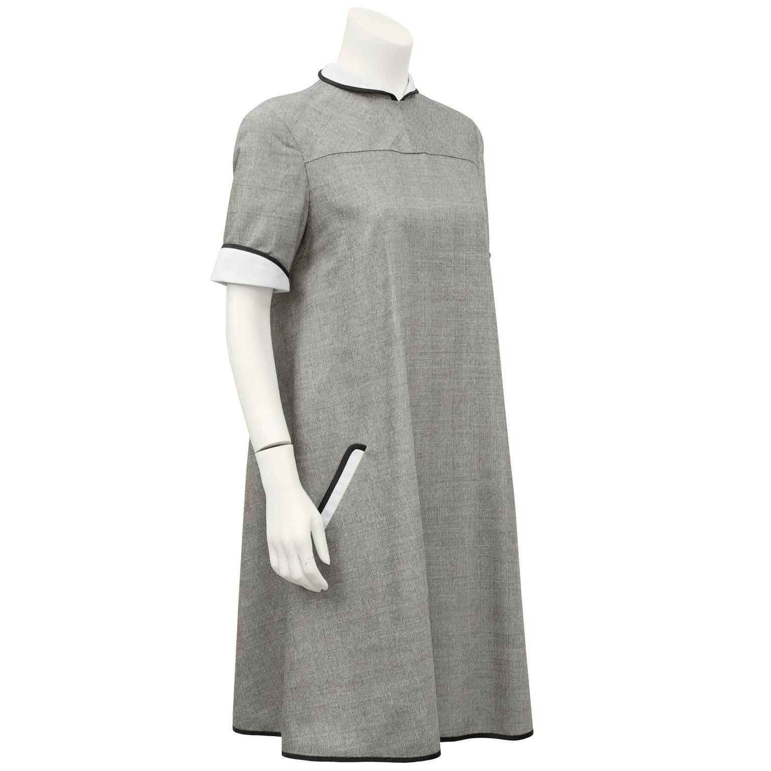 Darling 1980's Geoffrey Beene grey, black and white light weight wool glen check swing dress. Contrasting white cotton waffle fabric with black silk ribbon trim on  peter pan collar, pocket and short sleeves. Inverted pleats hang beautifully at back