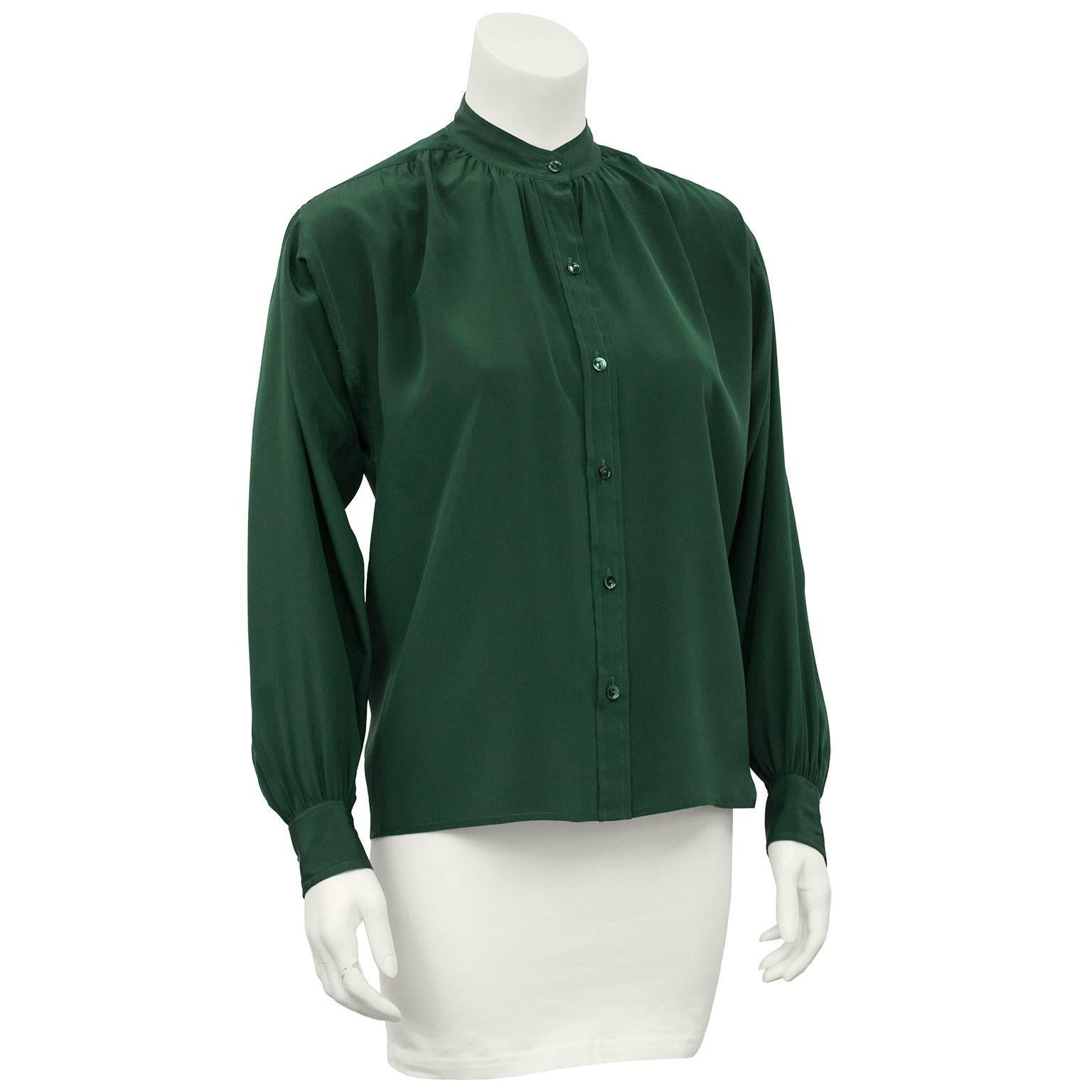 Classic Yves Saint Laurent blouse dating from the 1980s. Forest green silk with a Mandarin collar and slight dolman sleeves. Fits like a US 6. Excellent vintage condition. 

Sleeve 21" Shoulder 24" Bust 40" Waist 40" Hips
