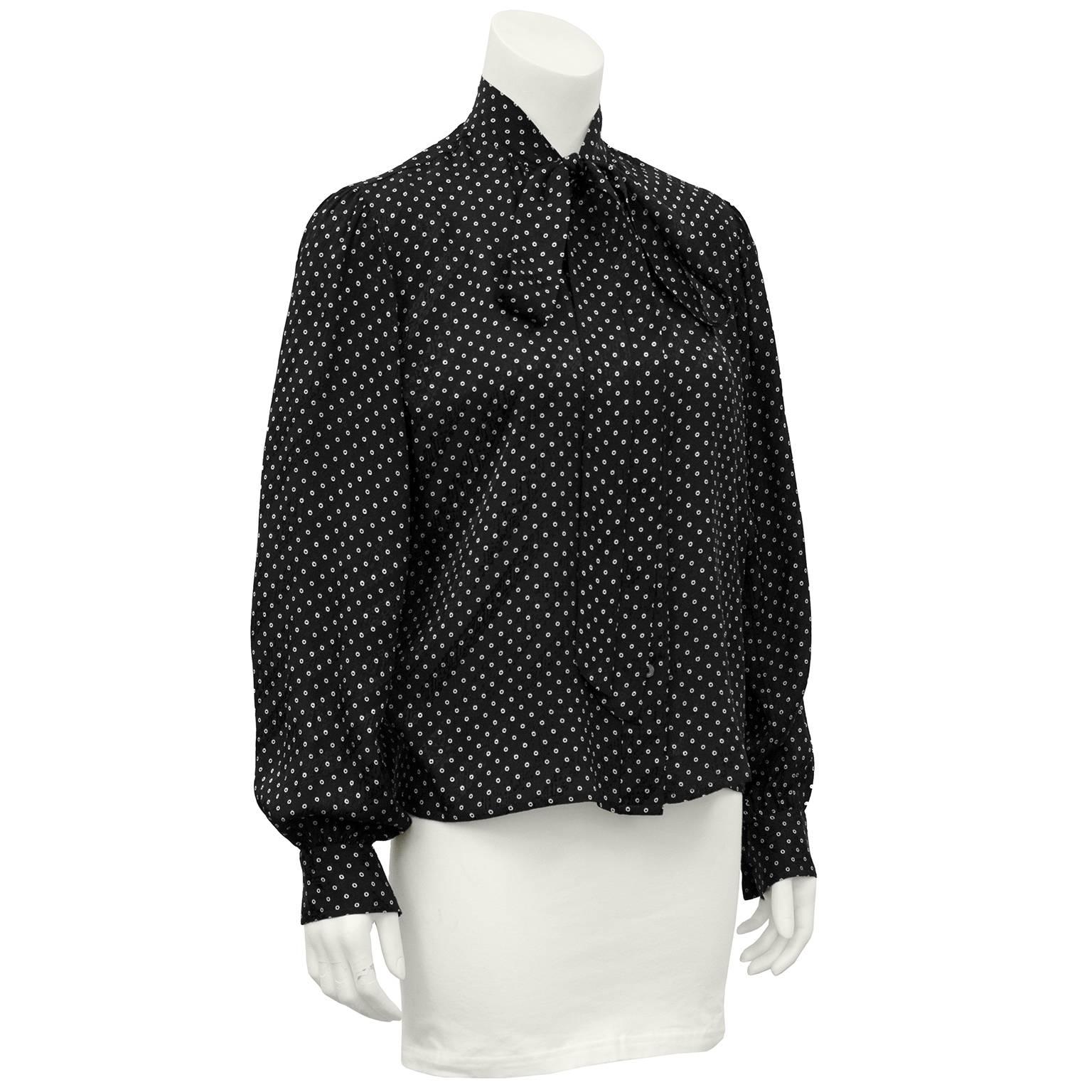 Classic YSL 1980's blouse. Black silk jacquard with small white polka dots. Thin pussy bow neck tie. Marked size FR 42, fits like a US 6. Excellent vintage condition. 

Sleeve 21" Shoulder 25" Bust 42" Waist 42" Hips 42"
